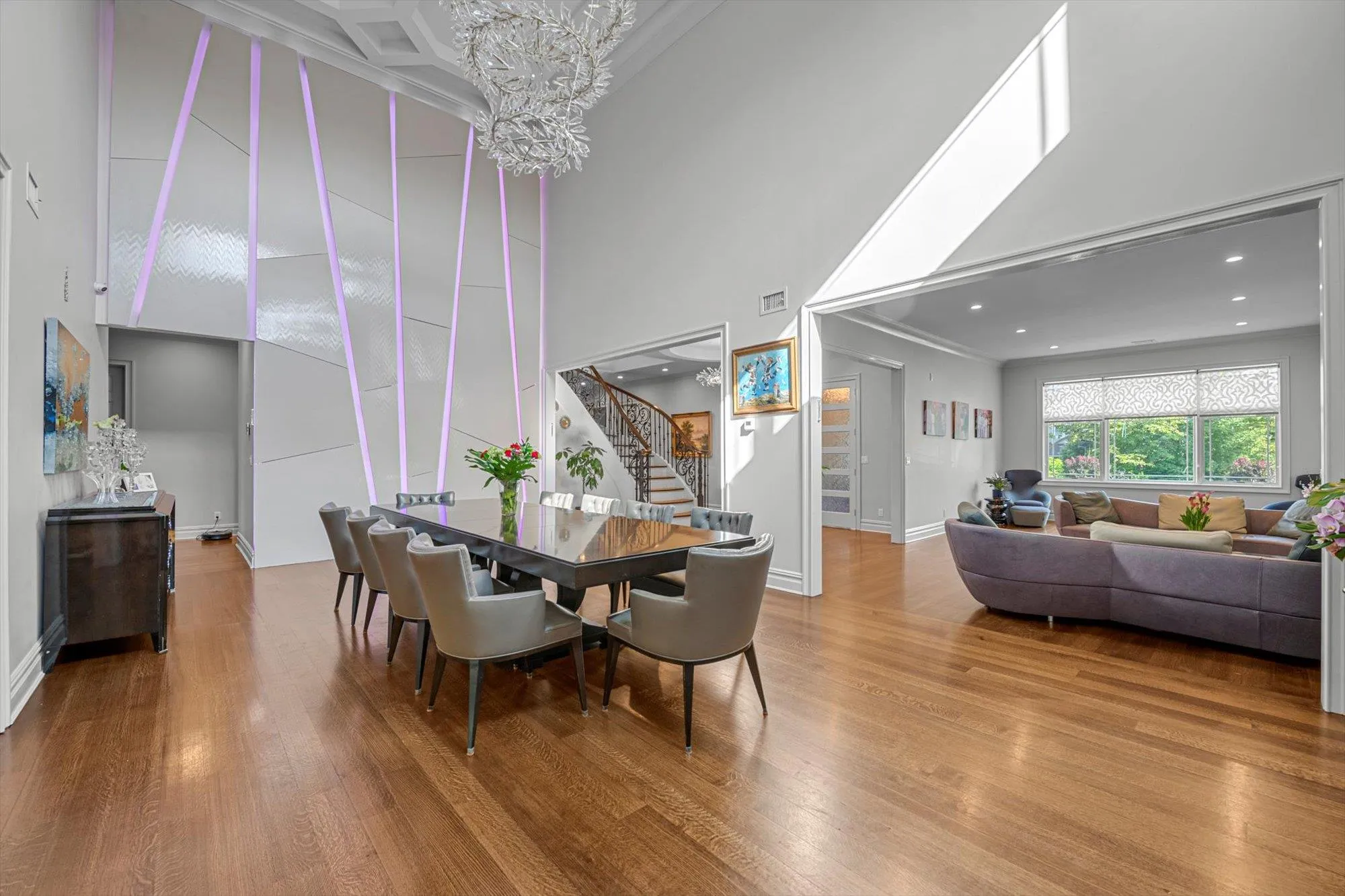 Forml Dining Room featuring a towering 20' ceiling, wood finished floors, crown molding, and a chandelier Forml Dining Room featuring a towering 20' ceiling, wood finished floors, crown molding, and a chandelier