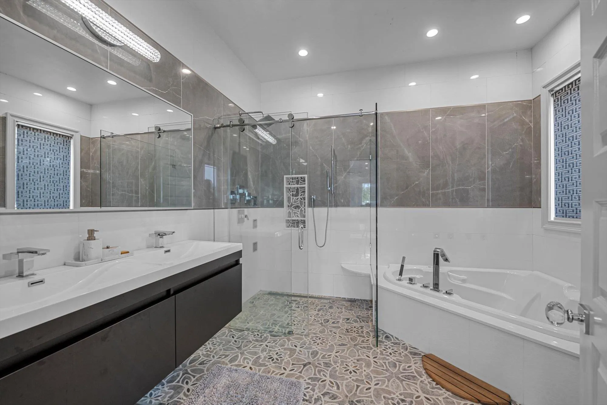 Main Floor Primary Bathroom featuring a garden tub, a stall shower, recessed lighting, double vanity, and tile walls Main Floor Primary Bathroom featuring a garden tub, a stall shower, recessed lighting, double vanity, and tile walls