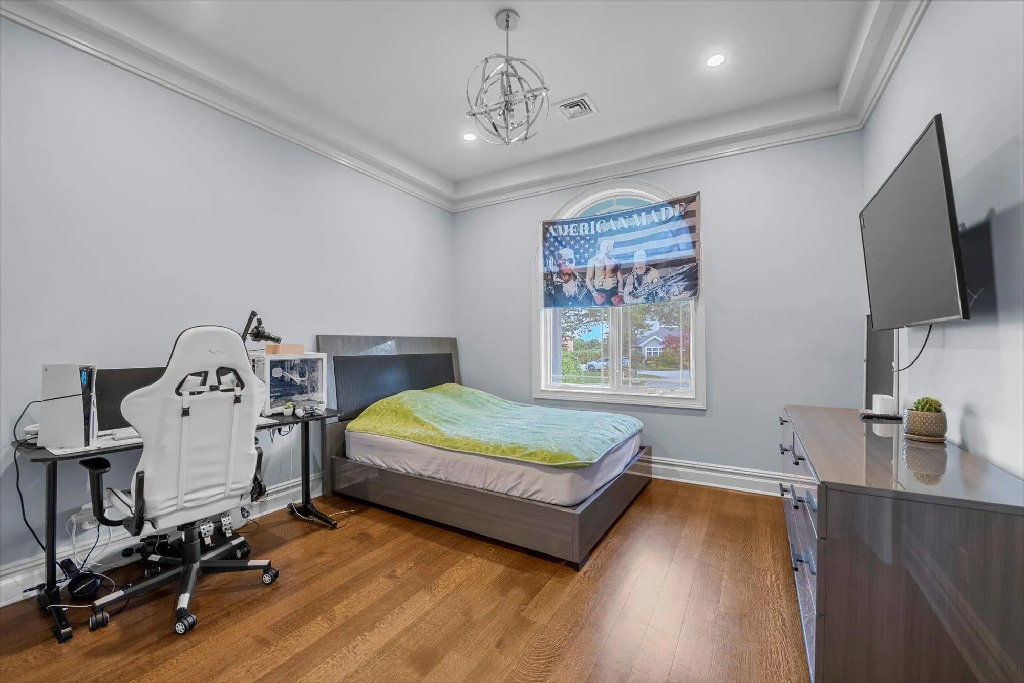 Bedroom with wood finished floors, recessed lighting, a chandelier, and ornamental molding Bedroom with wood finished floors, recessed lighting, a chandelier, and ornamental molding