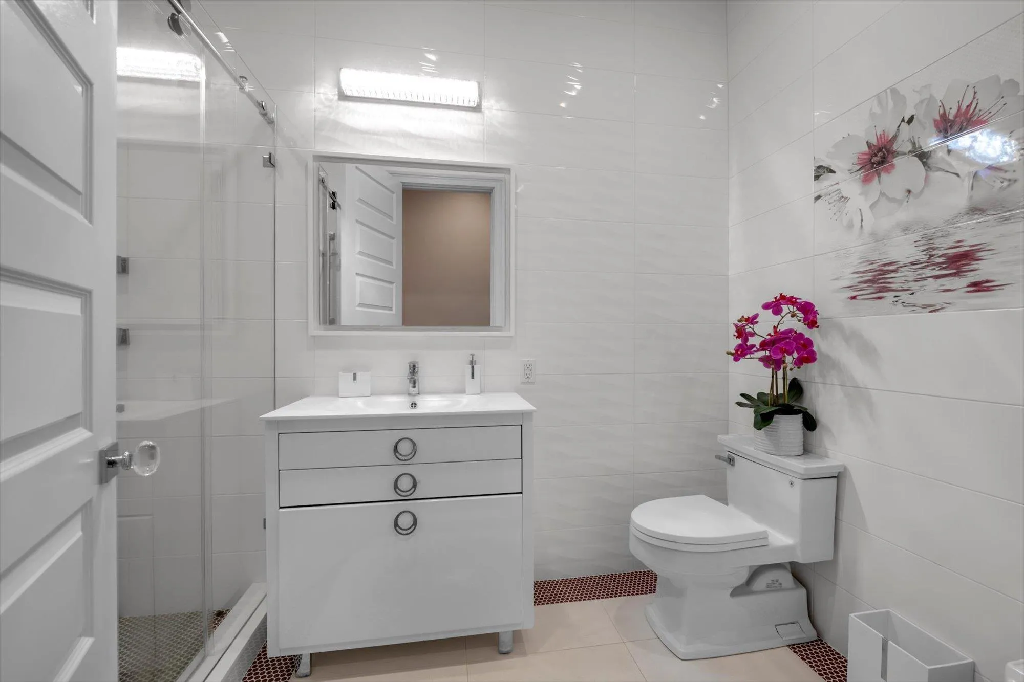 Bathroom featuring vanity, tile walls, tile patterned flooring, and a shower stall Bathroom featuring vanity, tile walls, tile patterned flooring, and a shower stall