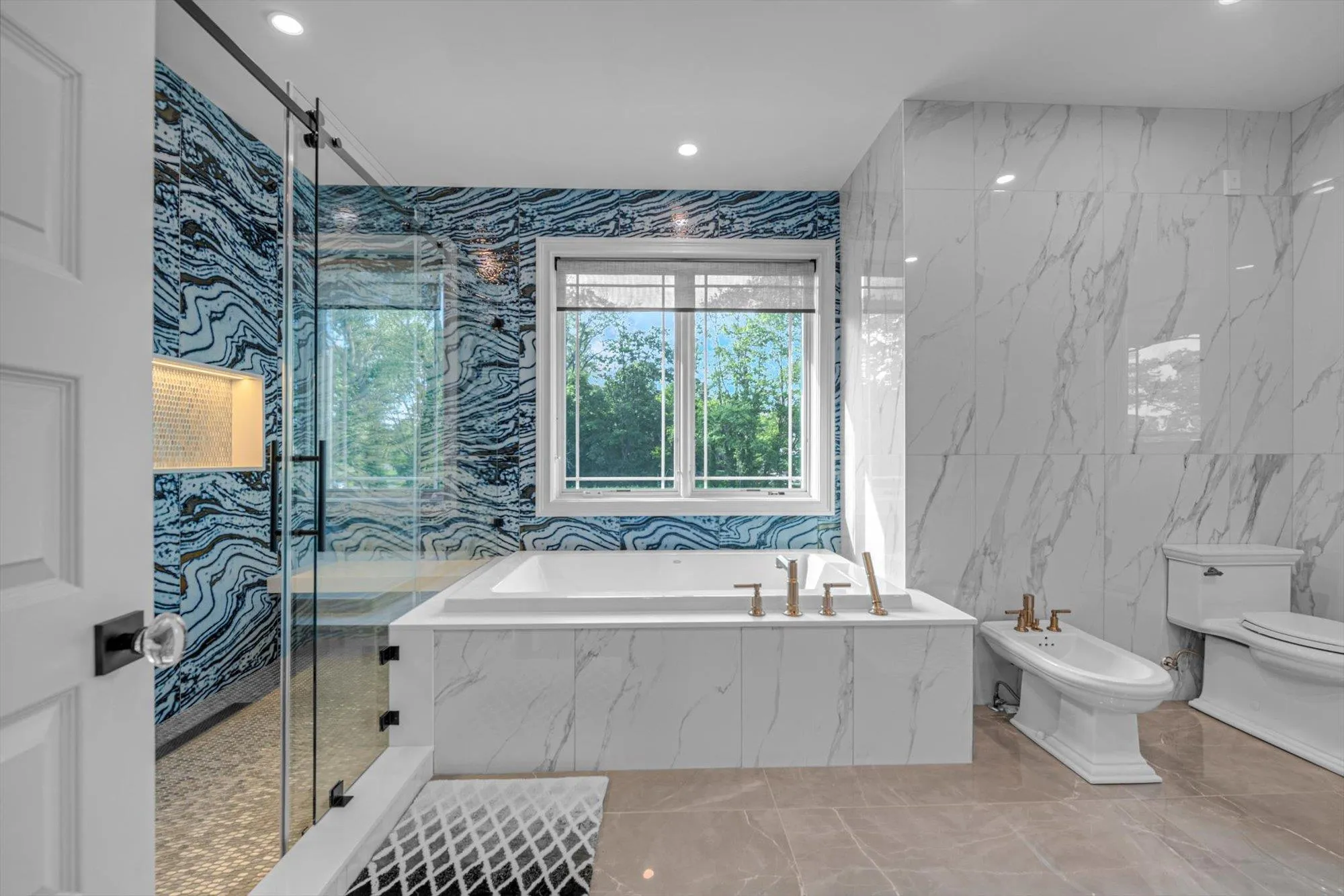 Primary Spa Bathroom with a bidet, a bath, a marble finish shower, marble finish floors, and recessed lighting Primary Spa Bathroom with a bidet, a bath, a marble finish shower, marble finish floors, and recessed lighting