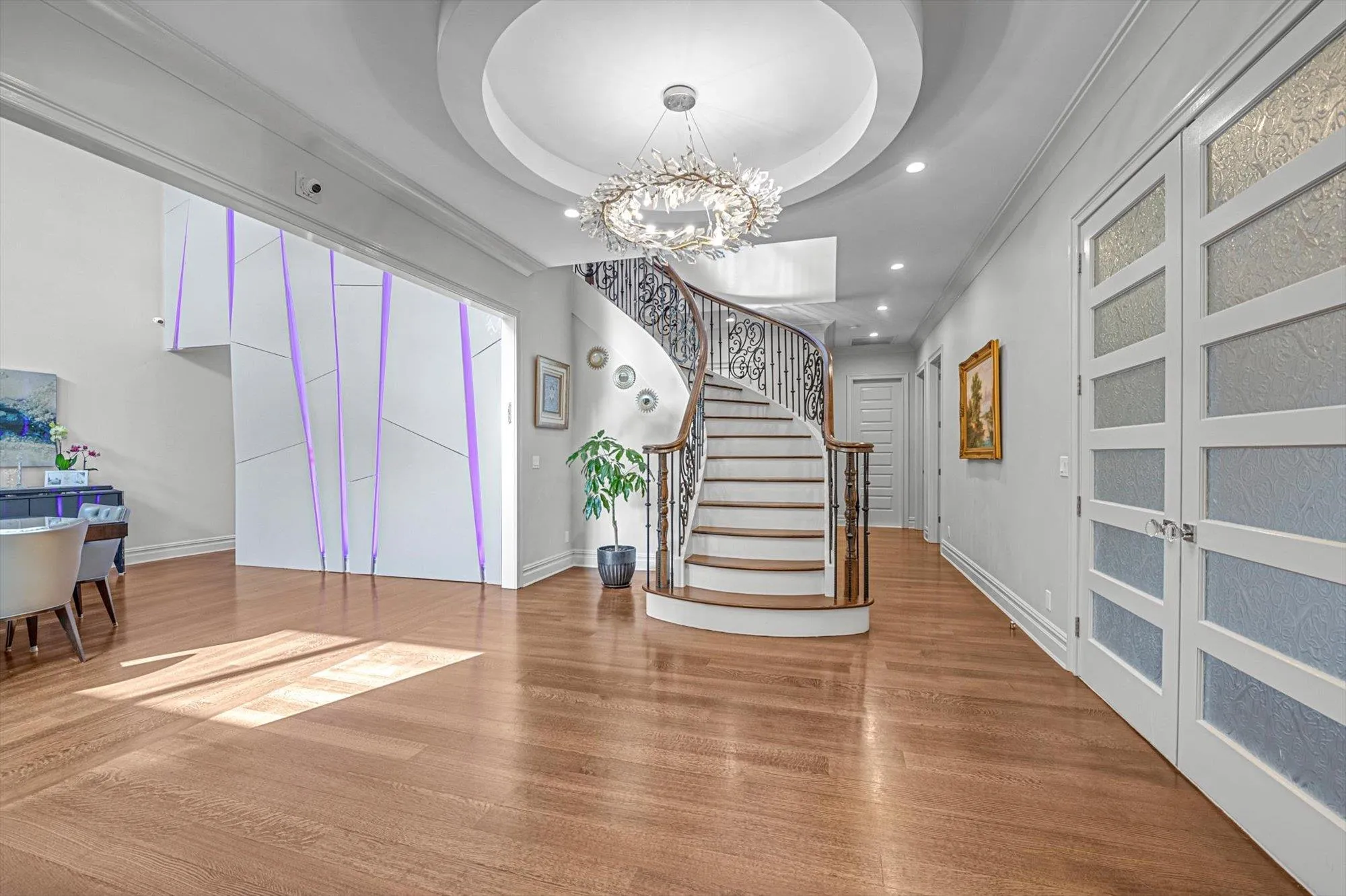 Entrance foyer featuring wood finished floors, a chandelier, stairs, recessed lighting, and a tray ceiling Entrance foyer featuring wood finished floors, a chandelier, stairs, recessed lighting, and a tray ceiling