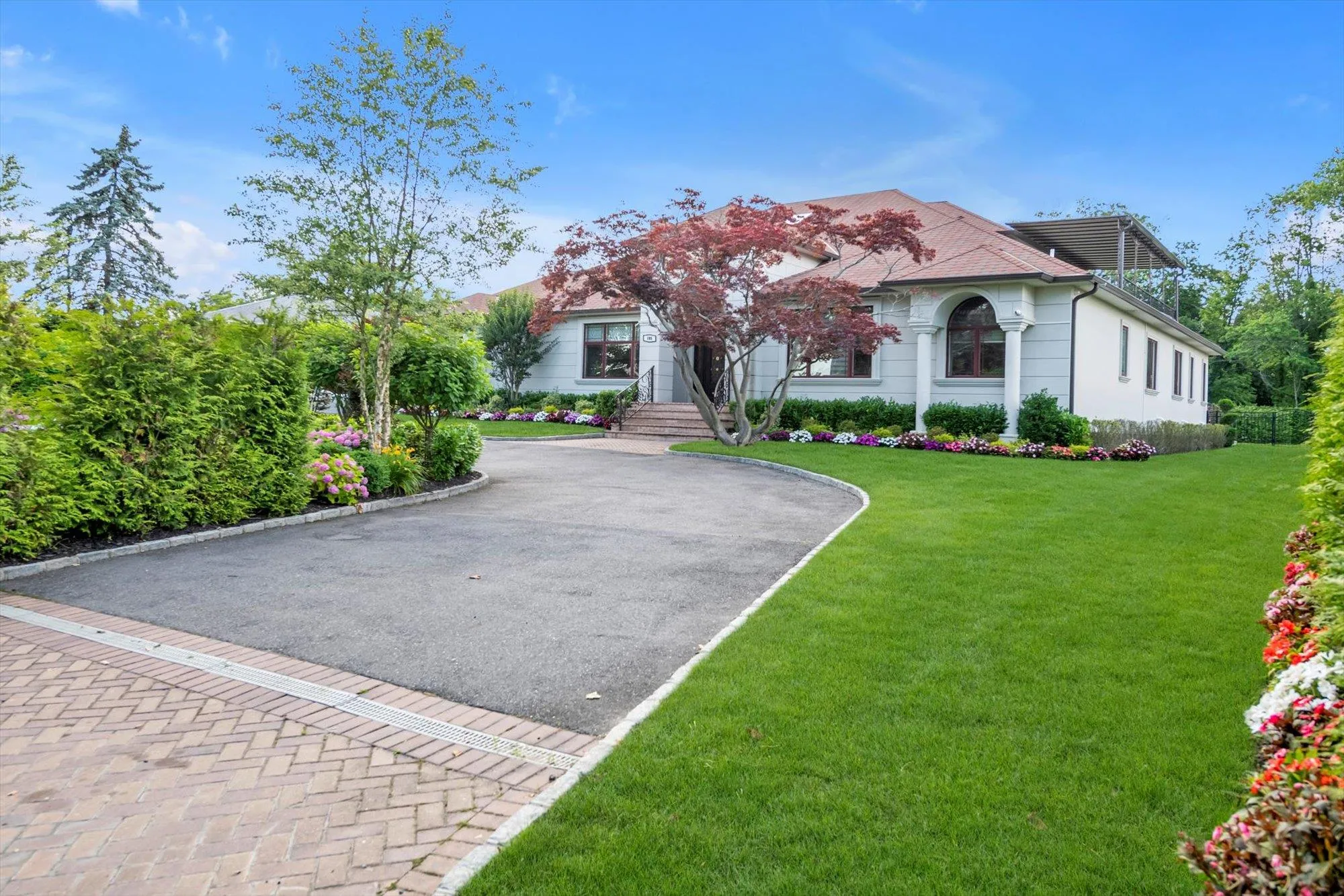 View of front of home with Circular driveway and a front lawn View of front of home with Circular driveway and a front lawn