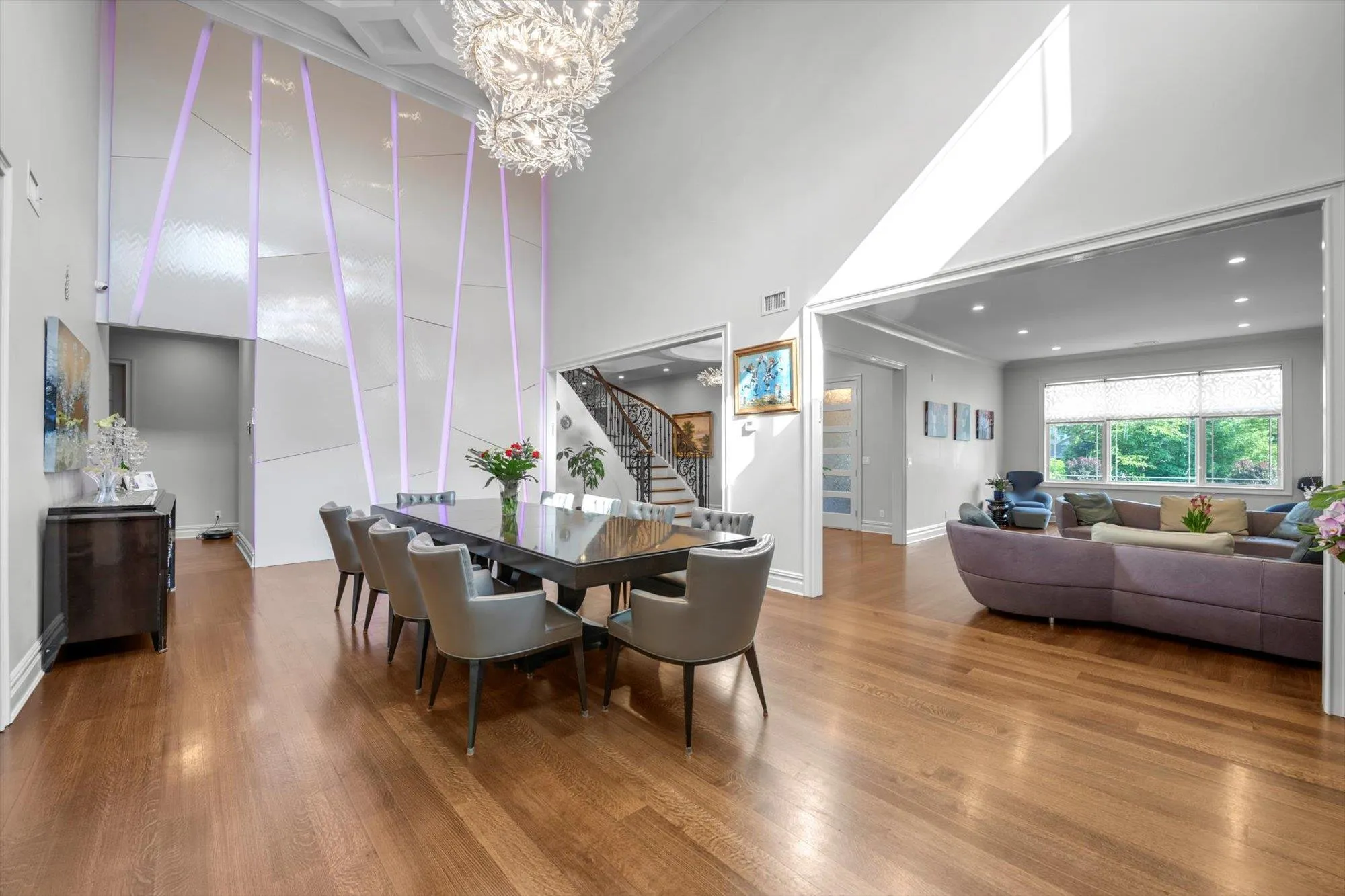 Formal Dining Room featuring wood finished floors, a 20' ceiling, and a chandelier Formal Dining Room featuring wood finished floors, a 20' ceiling, and a chandelier