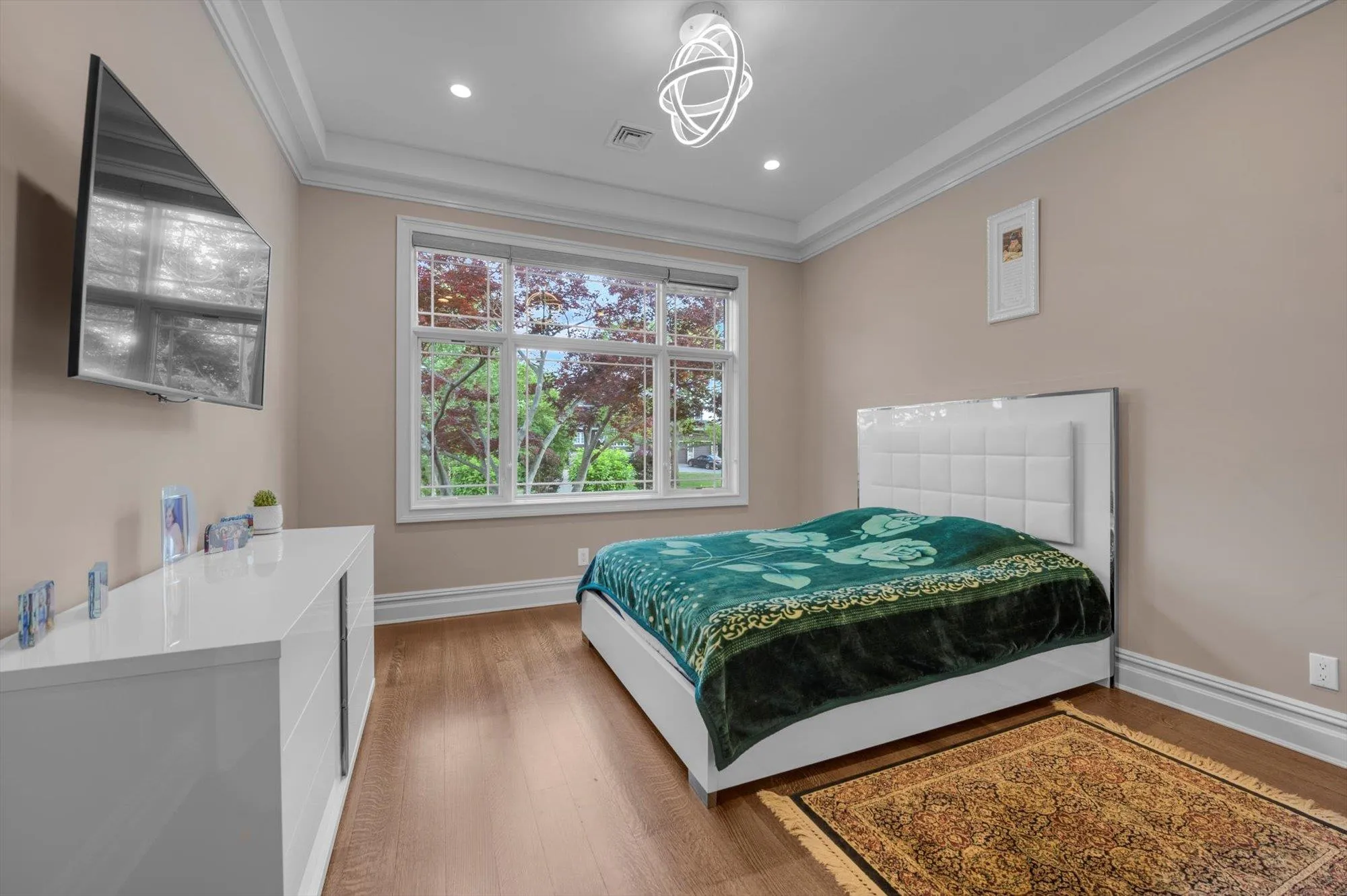 Bedroom with crown molding, wood finished floors, and recessed lighting Bedroom with crown molding, wood finished floors, and recessed lighting