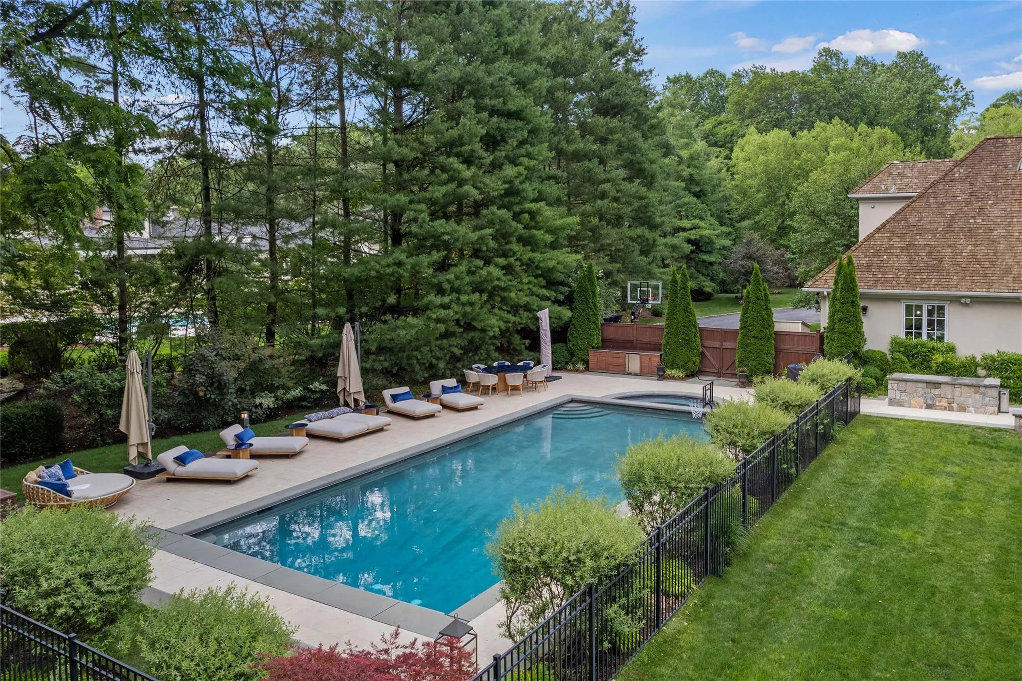 View of pool with a patio area and a pool with connected hot tub View of pool with a patio area and a pool with connected hot tub