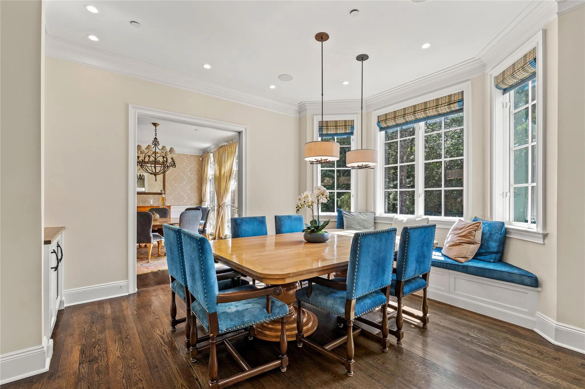Dining room featuring a chandelier, dark wood-style floors, ornamental molding, and recessed lighting Dining room featuring a chandelier, dark wood-style floors, ornamental molding, and recessed lighting