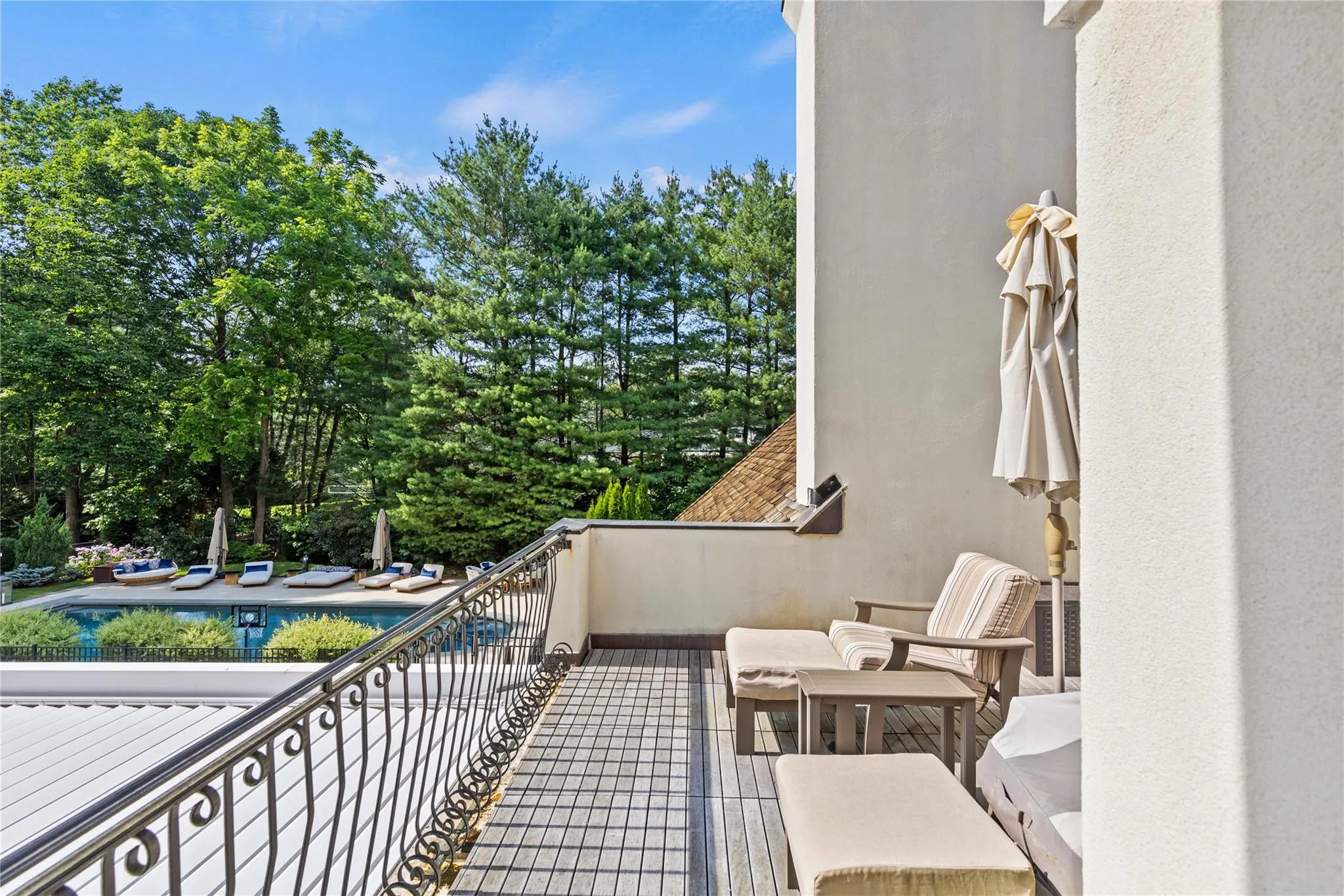 Balcony with view of the pool and beautifully landscaped back yard Balcony with view of the pool and beautifully landscaped back yard