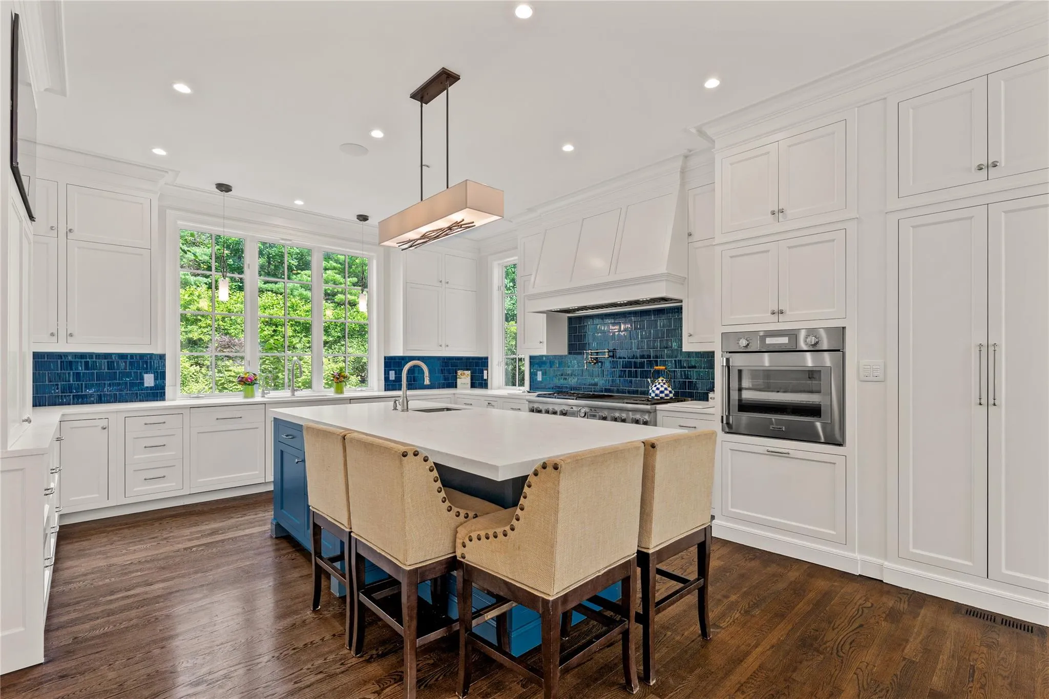 Kitchen featuring appliances with stainless steel finishes, white cabinets, light countertops, backsplash, and recessed lighting Kitchen featuring appliances with stainless steel finishes, white cabinets, light countertops, backsplash, and recessed lighting