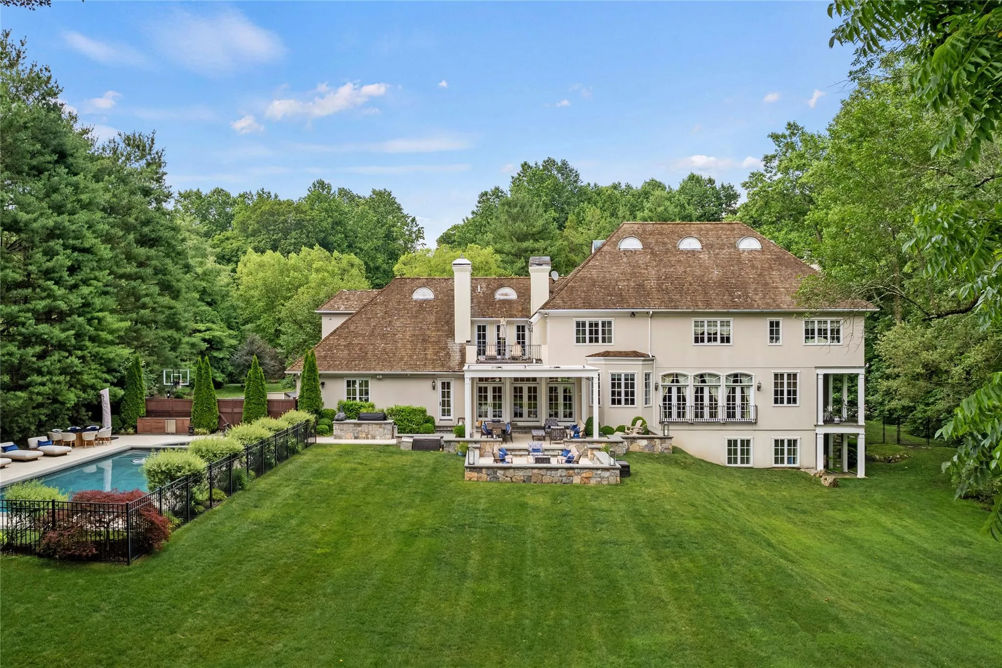 Rear view of property with stucco siding, a patio, french doors, and a chimney Rear view of property with stucco siding, a patio, french doors, and a chimney