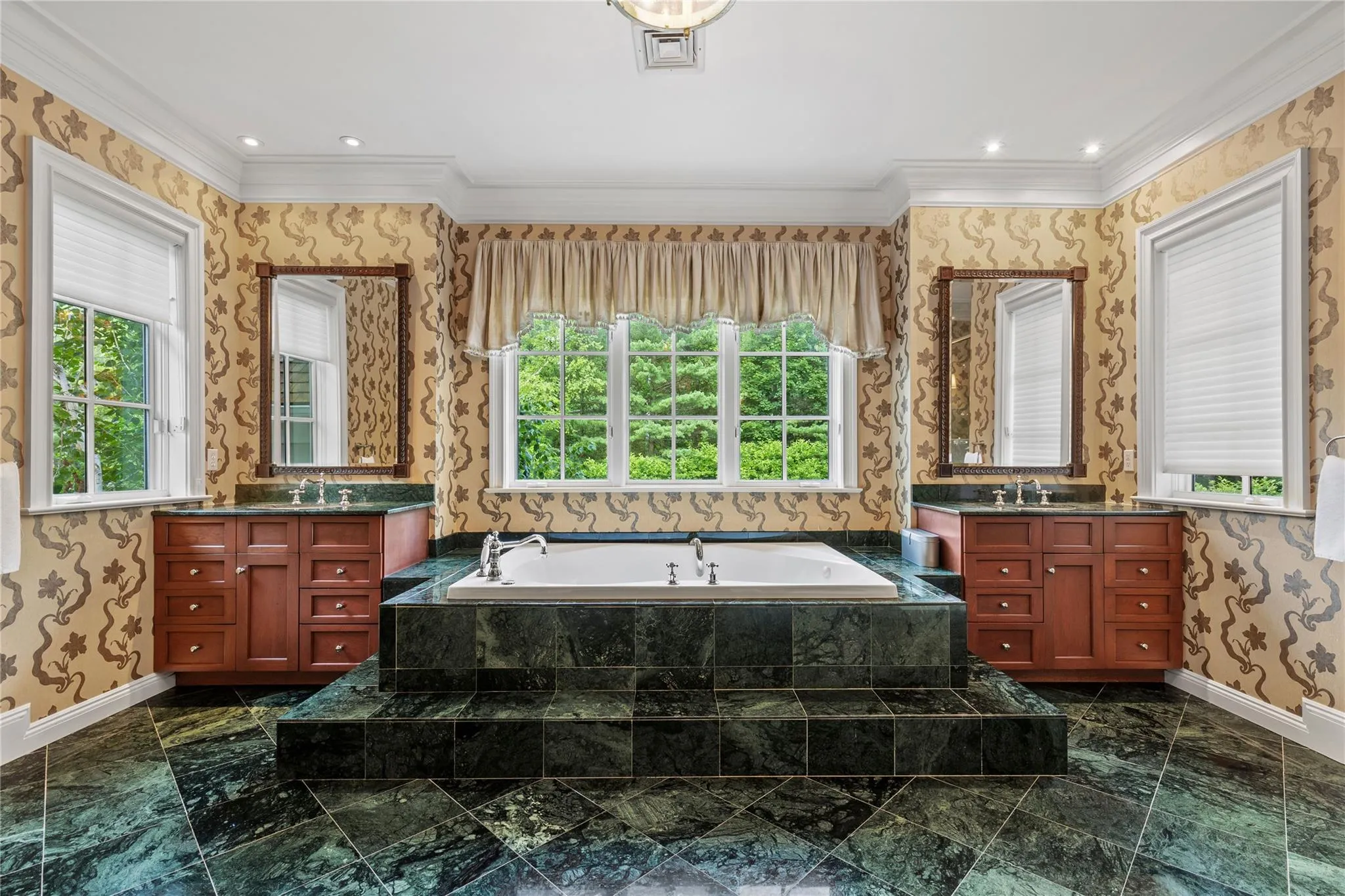 Full bathroom featuring marble finish floors, two vanities and a jacuzzi tub Full bathroom featuring marble finish floors, two vanities and a jacuzzi tub