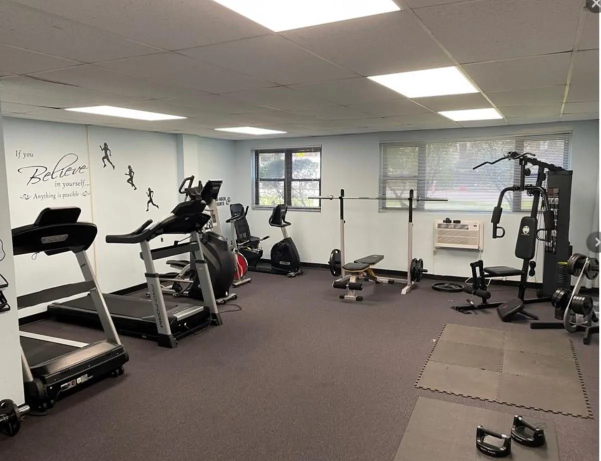 Workout area featuring a paneled ceiling and a wall unit AC Workout area featuring a paneled ceiling and a wall unit AC