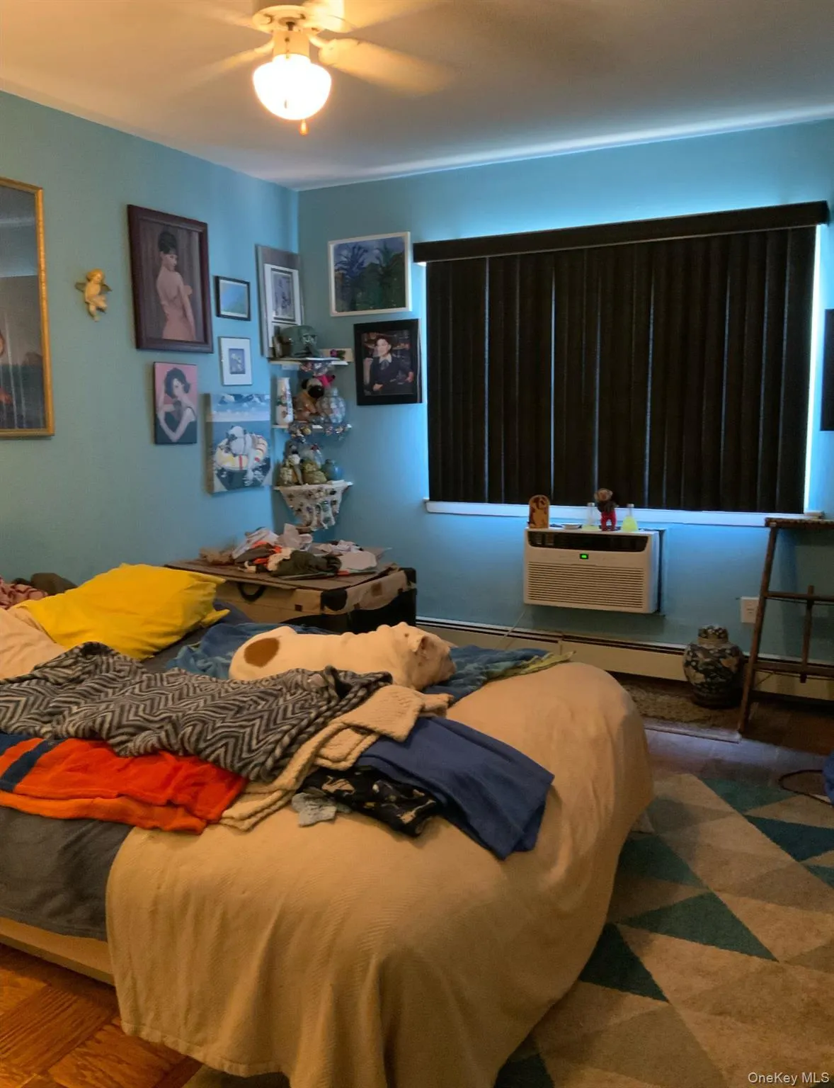 Bedroom featuring a wall mounted AC and a ceiling fan Bedroom featuring a wall mounted AC and a ceiling fan