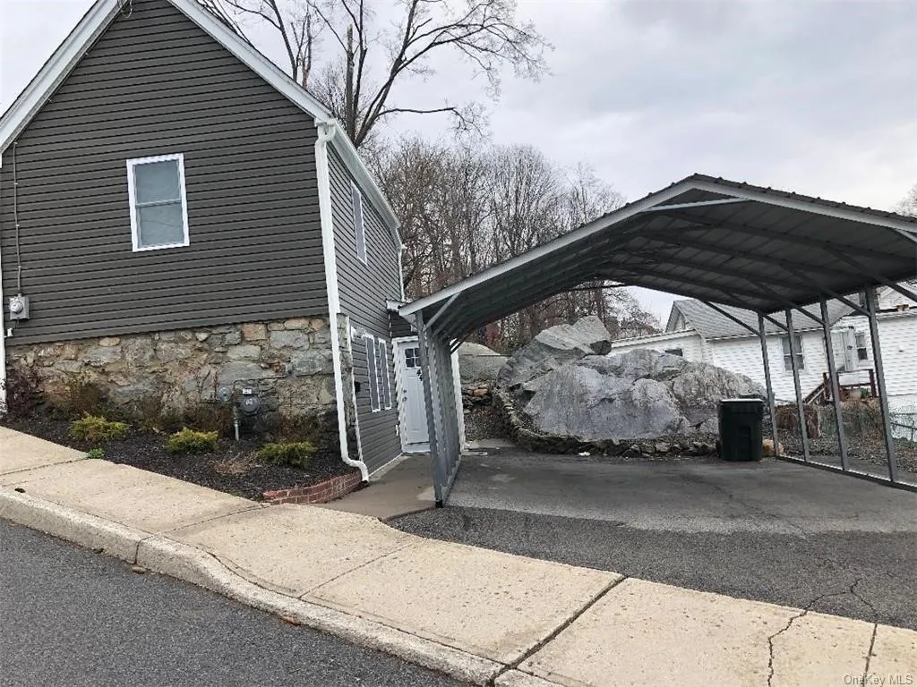 View of vehicle parking featuring a carport View of vehicle parking featuring a carport