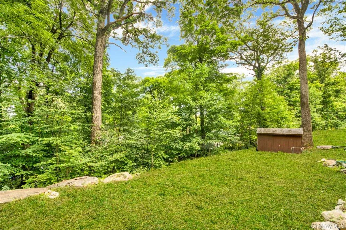 View of green lawn featuring a storage unit View of green lawn featuring a storage unit