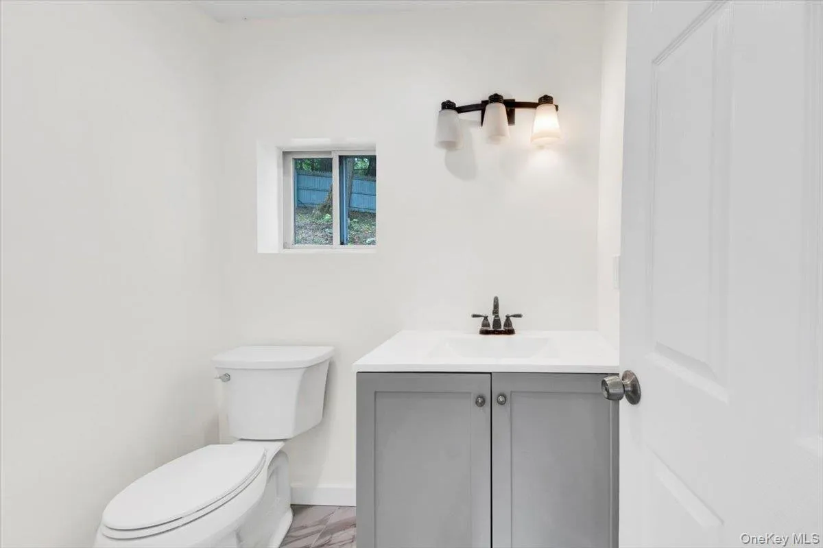 Bathroom with vanity and marble finish floors Bathroom with vanity and marble finish floors