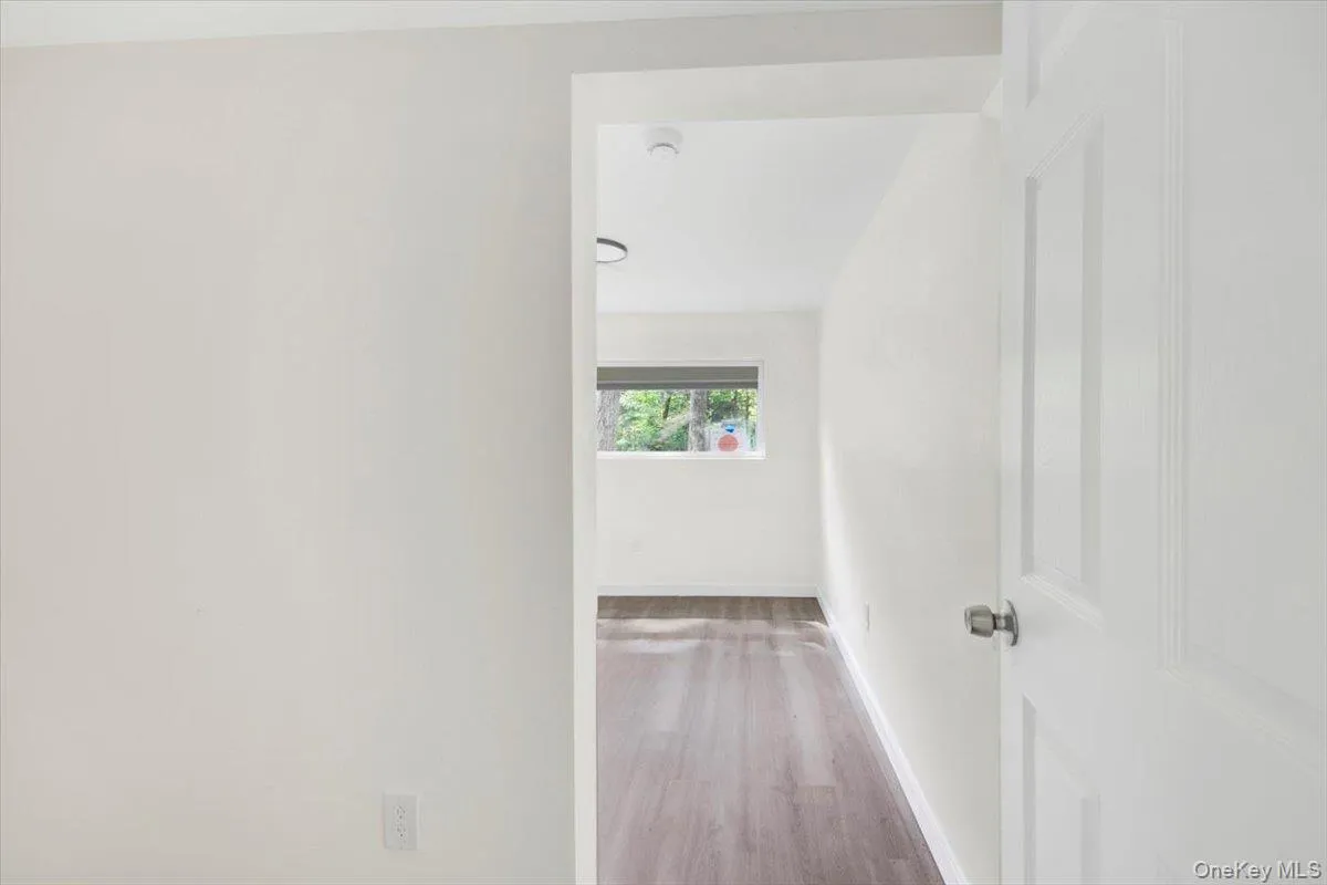 Corridor with wood finished floors and baseboards Corridor with wood finished floors and baseboards