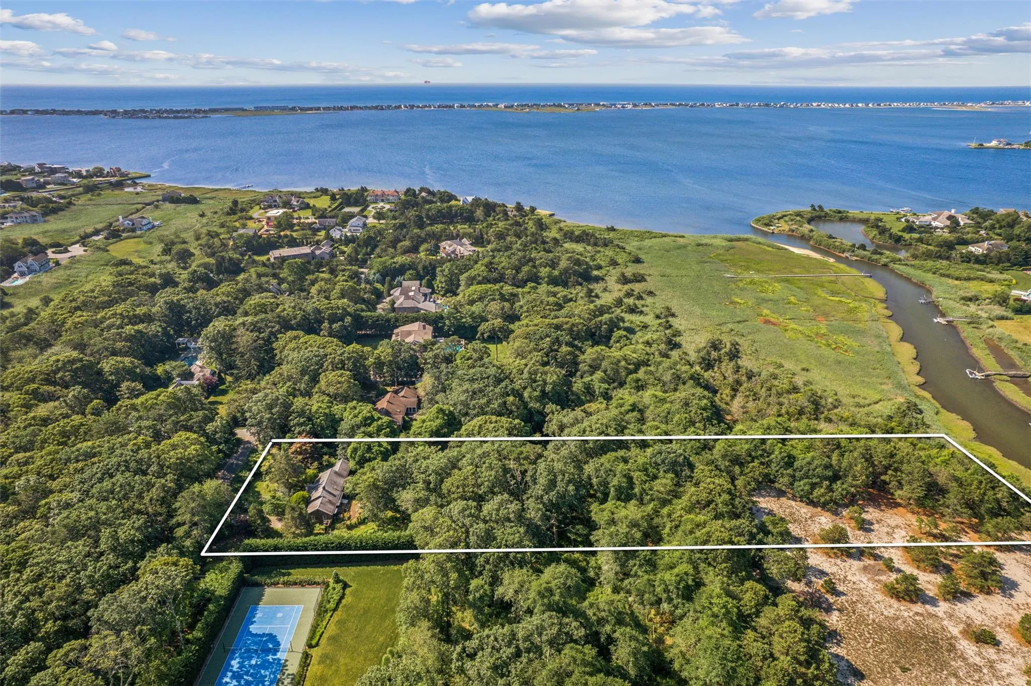 Aerial overview of property's location featuring a nearby body of water and property boundaries highlighted Aerial overview of property's location featuring a nearby body of water and property boundaries highlighted