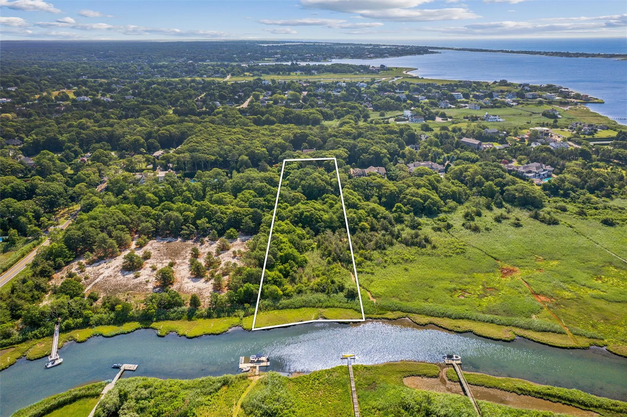 Aerial overview of property's location featuring a large body of water and property boundaries highlighted Aerial overview of property's location featuring a large body of water and property boundaries highlighted