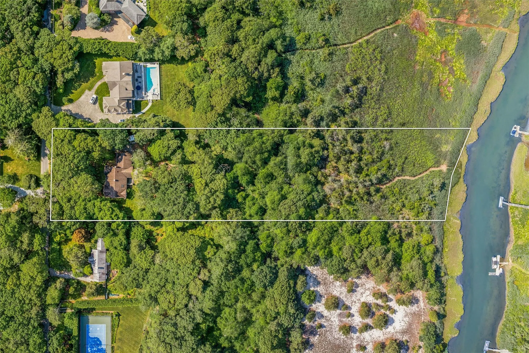 Aerial overview of property's location featuring a large body of water and property boundaries highlighted Aerial overview of property's location featuring a large body of water and property boundaries highlighted