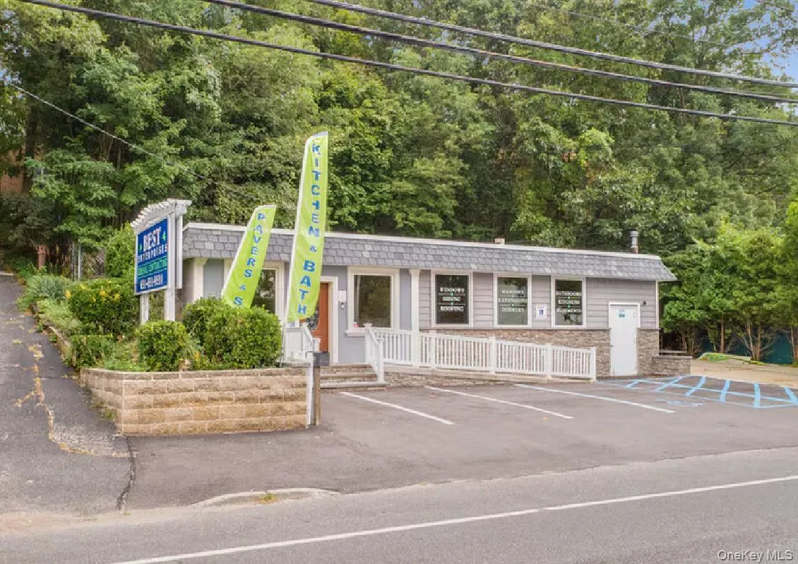 View of building exterior featuring uncovered parking View of building exterior featuring uncovered parking