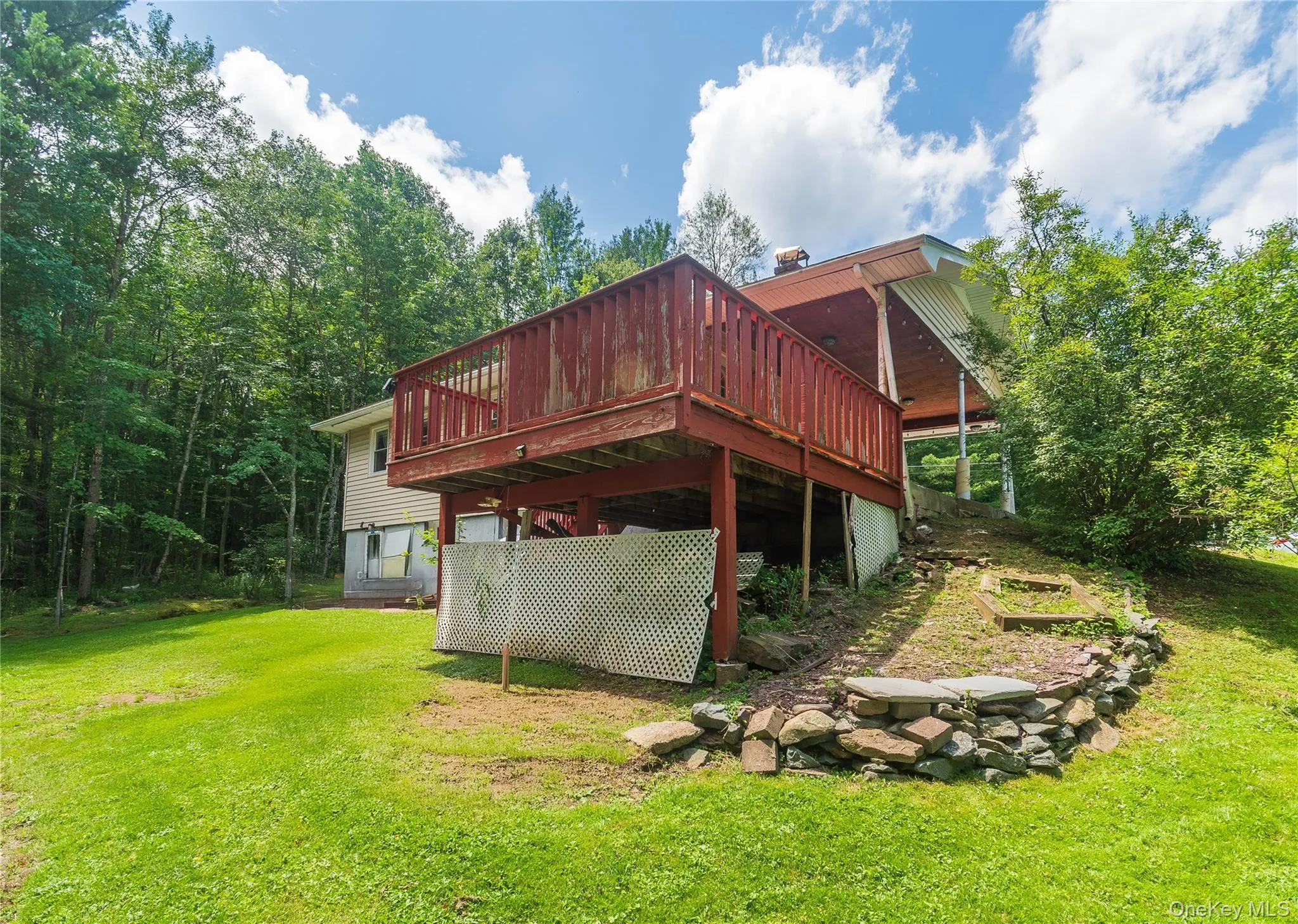 Rear view of house featuring a yard and a deck Rear view of house featuring a yard and a deck