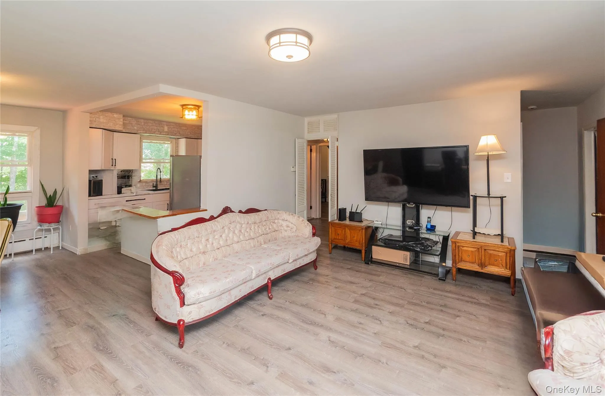 Living room with light wood-style flooring and baseboards Living room with light wood-style flooring and baseboards