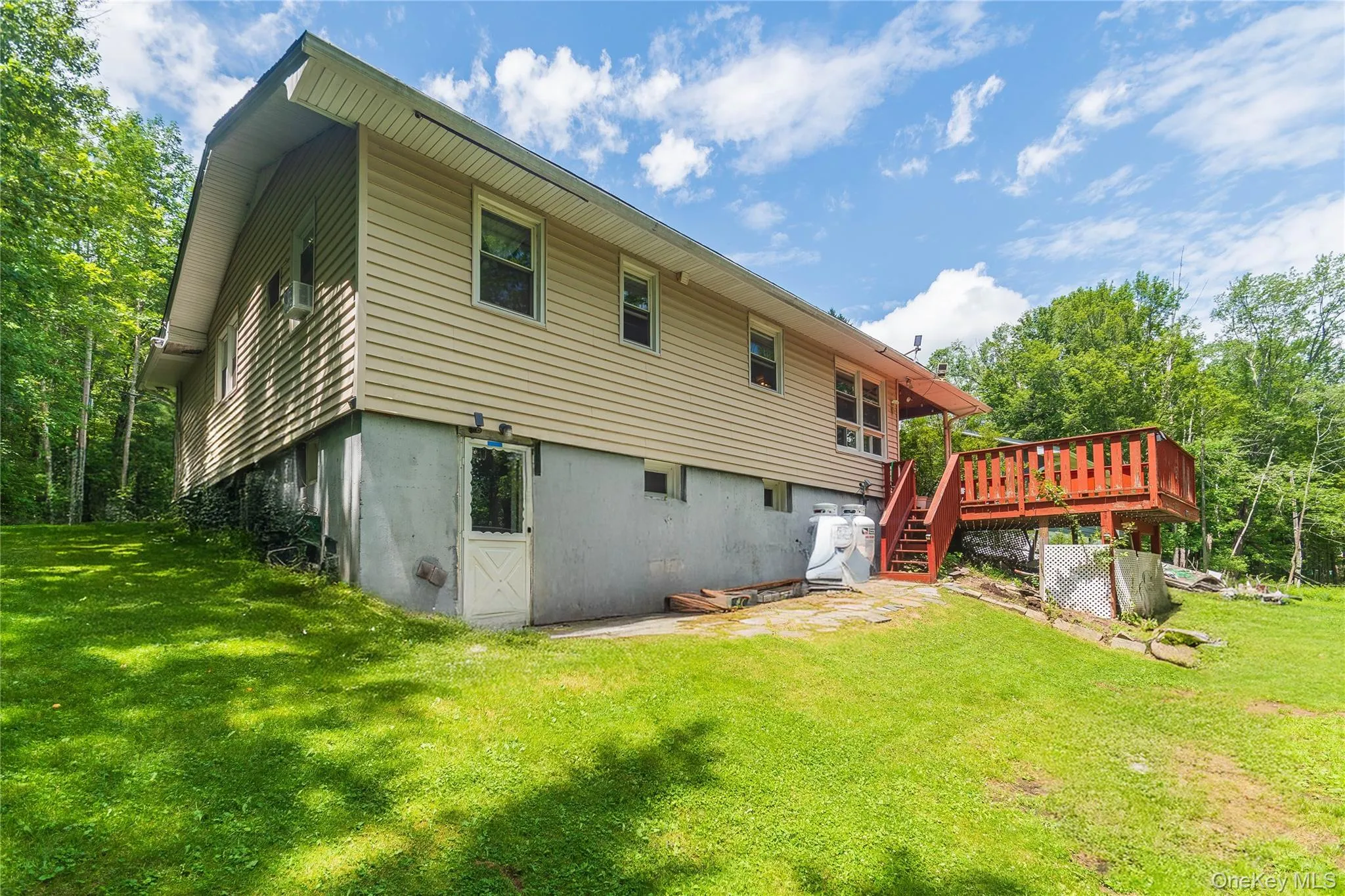 Rear view of house featuring a deck, a yard, and cooling unit Rear view of house featuring a deck, a yard, and cooling unit