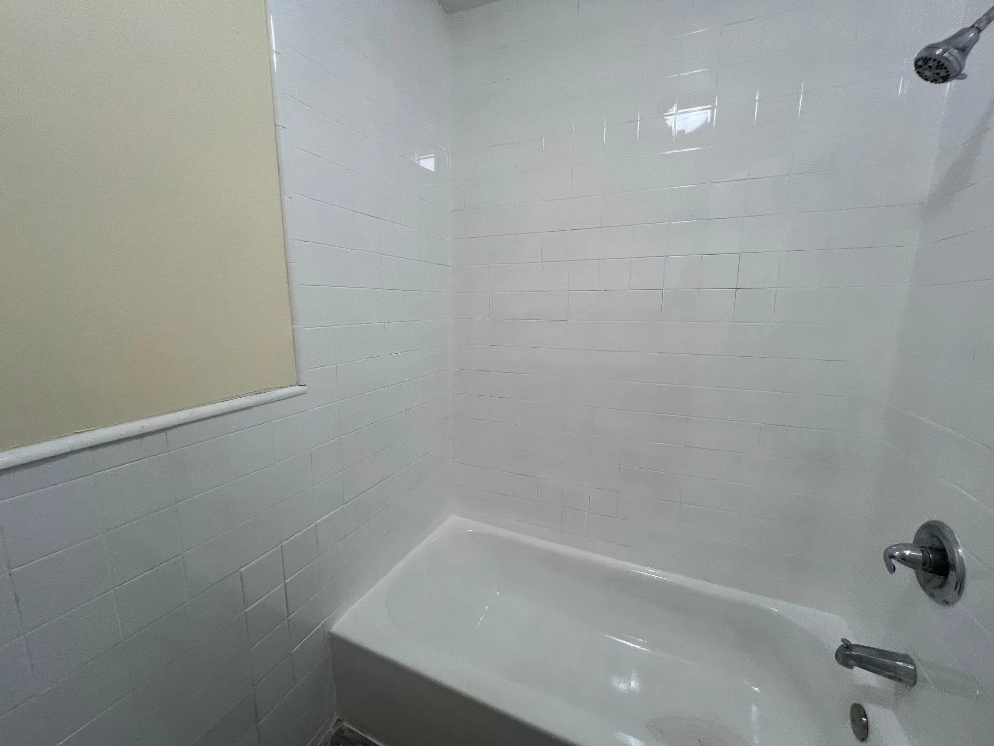 Full bathroom with shower / bath combination and tile walls Full bathroom with shower / bath combination and tile walls