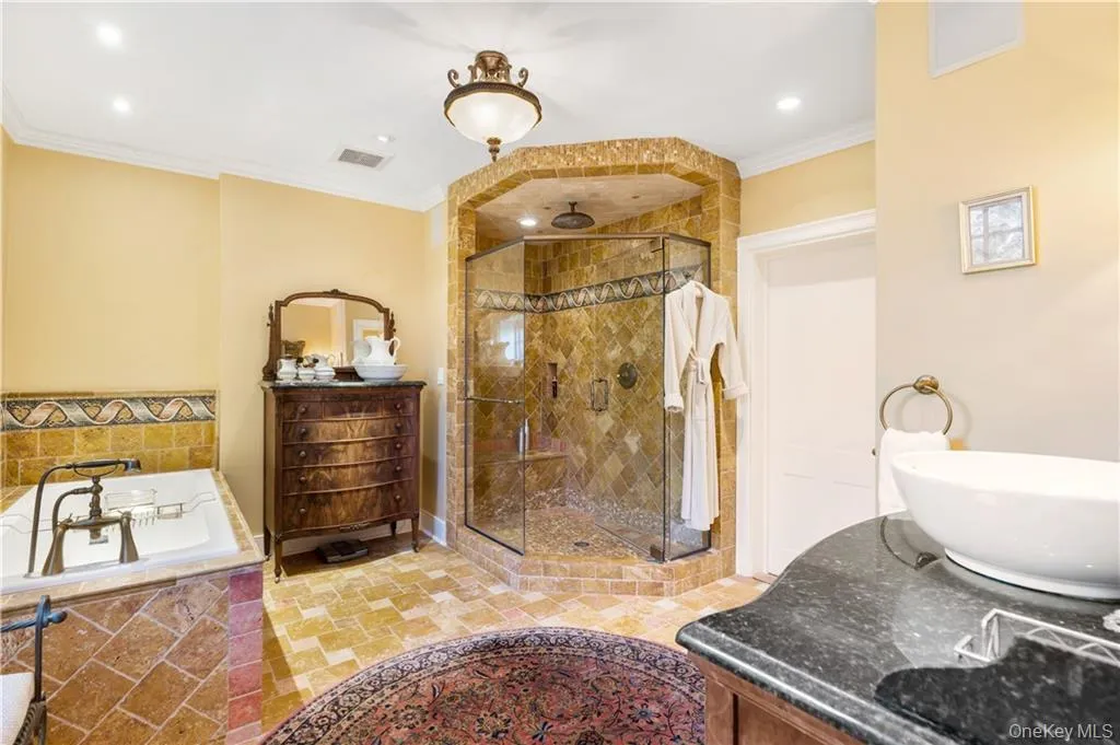 Bathroom with vanity, ornamental molding, a shower stall, a bath, and recessed lighting Bathroom with vanity, ornamental molding, a shower stall, a bath, and recessed lighting