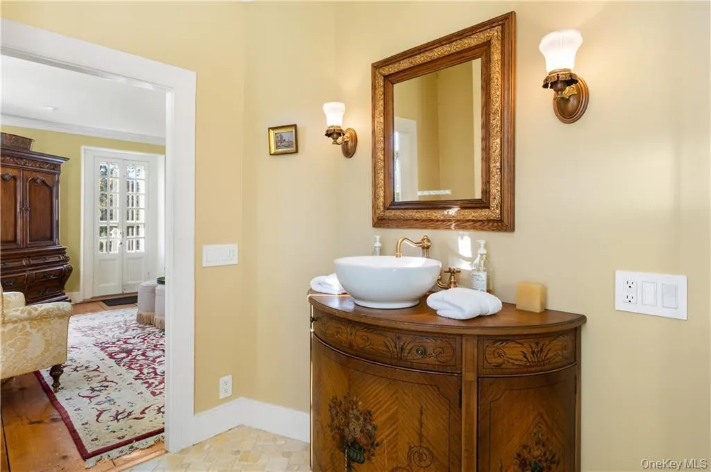 Bathroom featuring vanity and baseboards Bathroom featuring vanity and baseboards