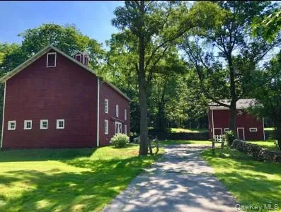 View of side of property with a yard and driveway View of side of property with a yard and driveway