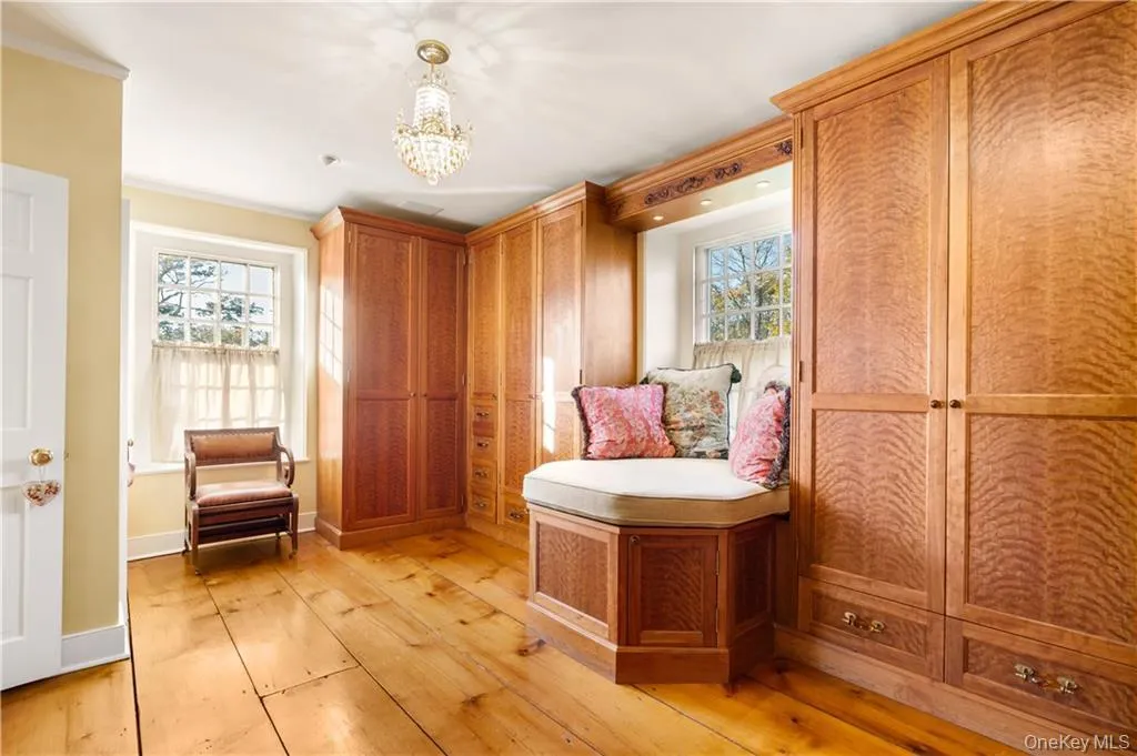 Sitting room featuring light wood-style flooring, a chandelier, and crown molding Sitting room featuring light wood-style flooring, a chandelier, and crown molding