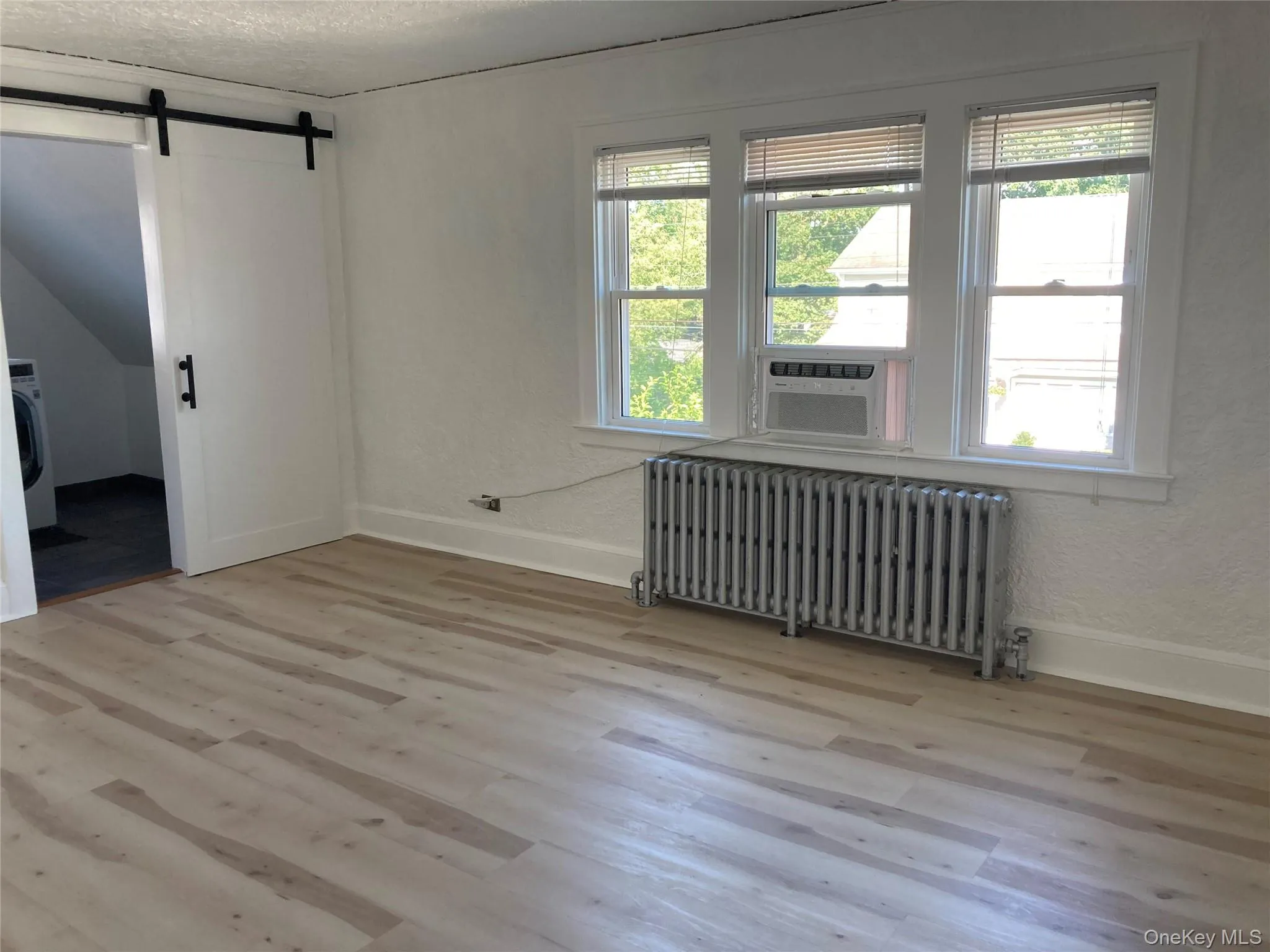 2nd FL Bedroom featuring wood finished floors, plenty of natural light, and a textured ceiling 2nd FL Bedroom featuring wood finished floors, plenty of natural light, and a textured ceiling