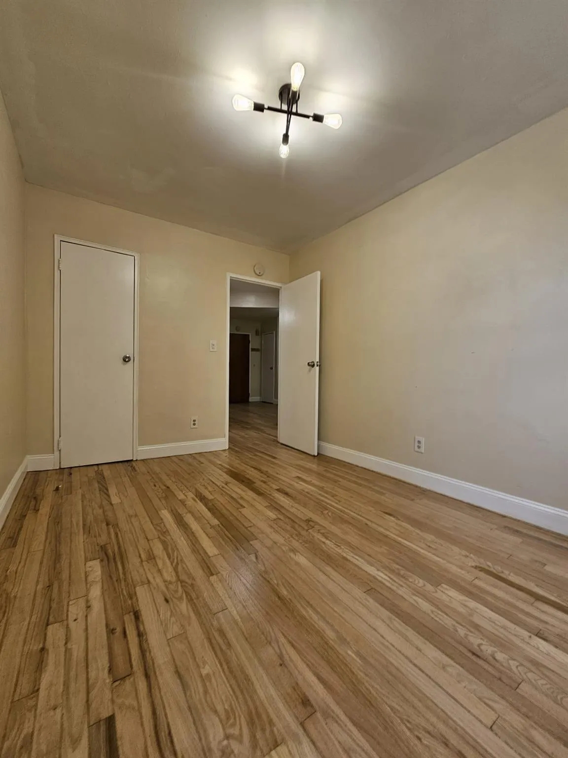 Unfurnished room with light wood-style flooring Unfurnished room with light wood-style flooring