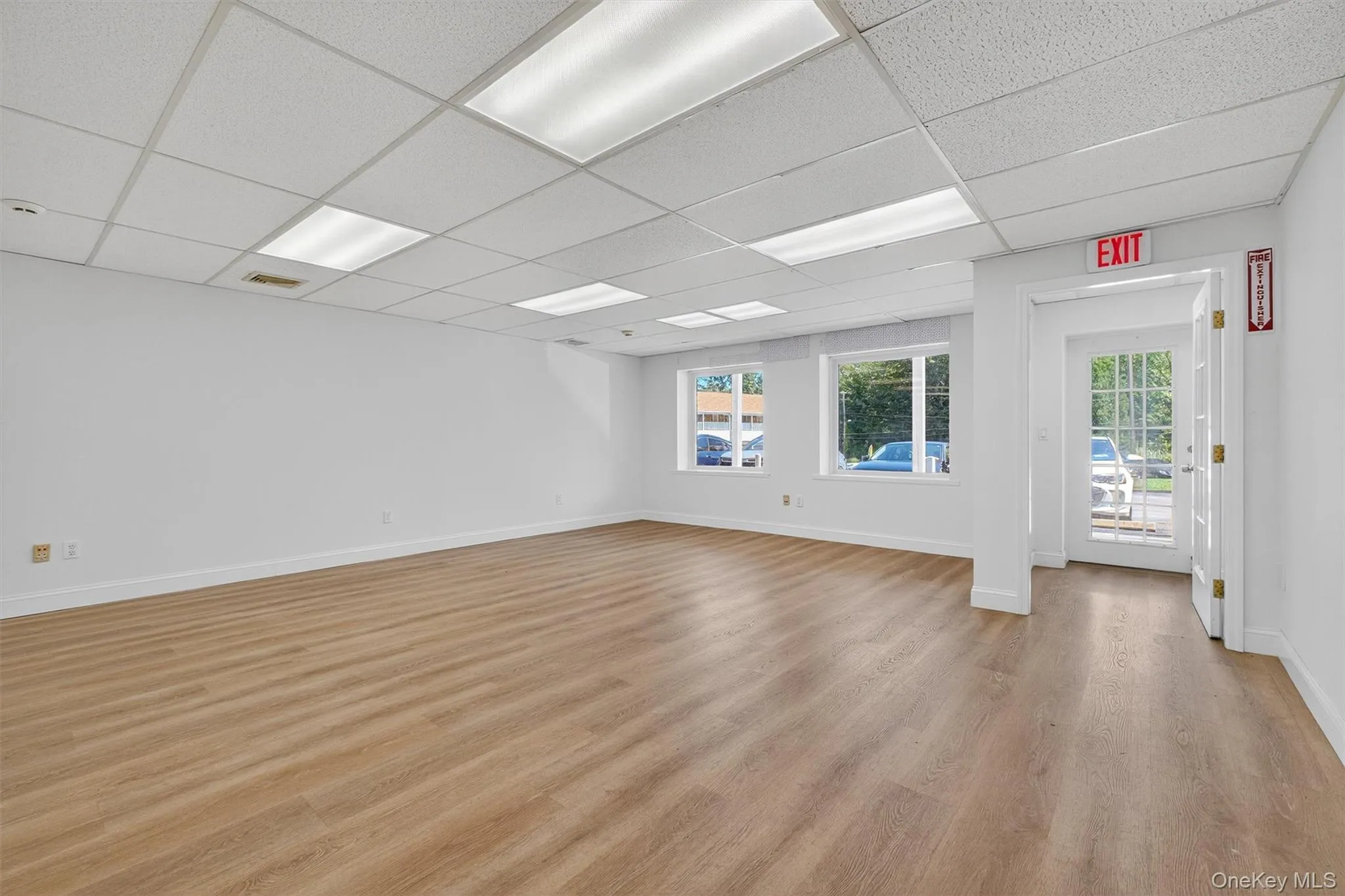 Spare room featuring a paneled ceiling and light wood-style flooring Spare room featuring a paneled ceiling and light wood-style flooring
