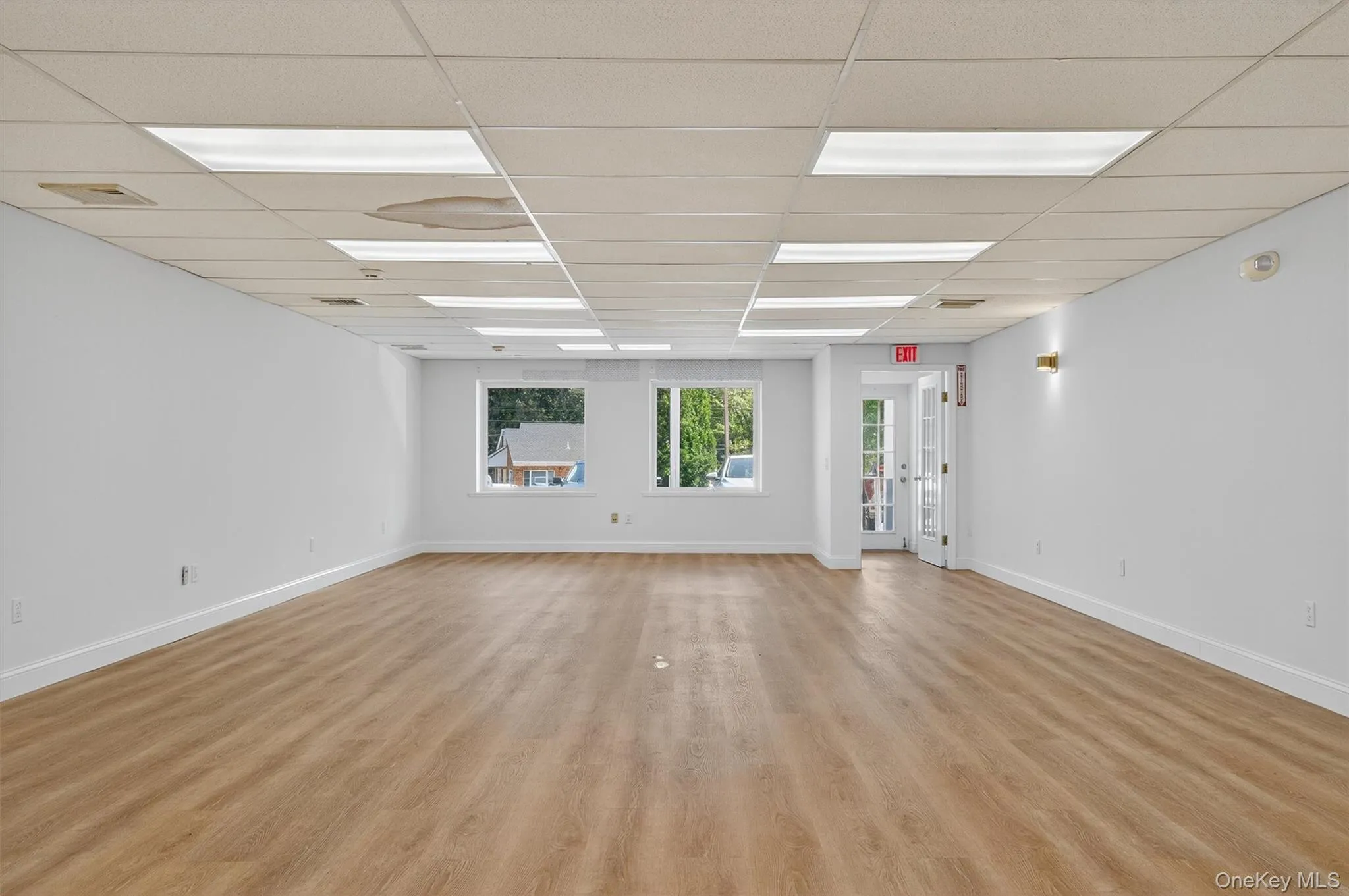 Unfurnished room featuring a drop ceiling and light wood finished floors Unfurnished room featuring a drop ceiling and light wood finished floors