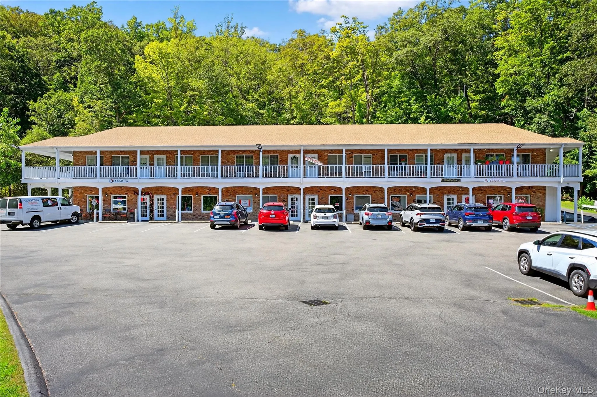 View of building exterior with uncovered parking View of building exterior with uncovered parking