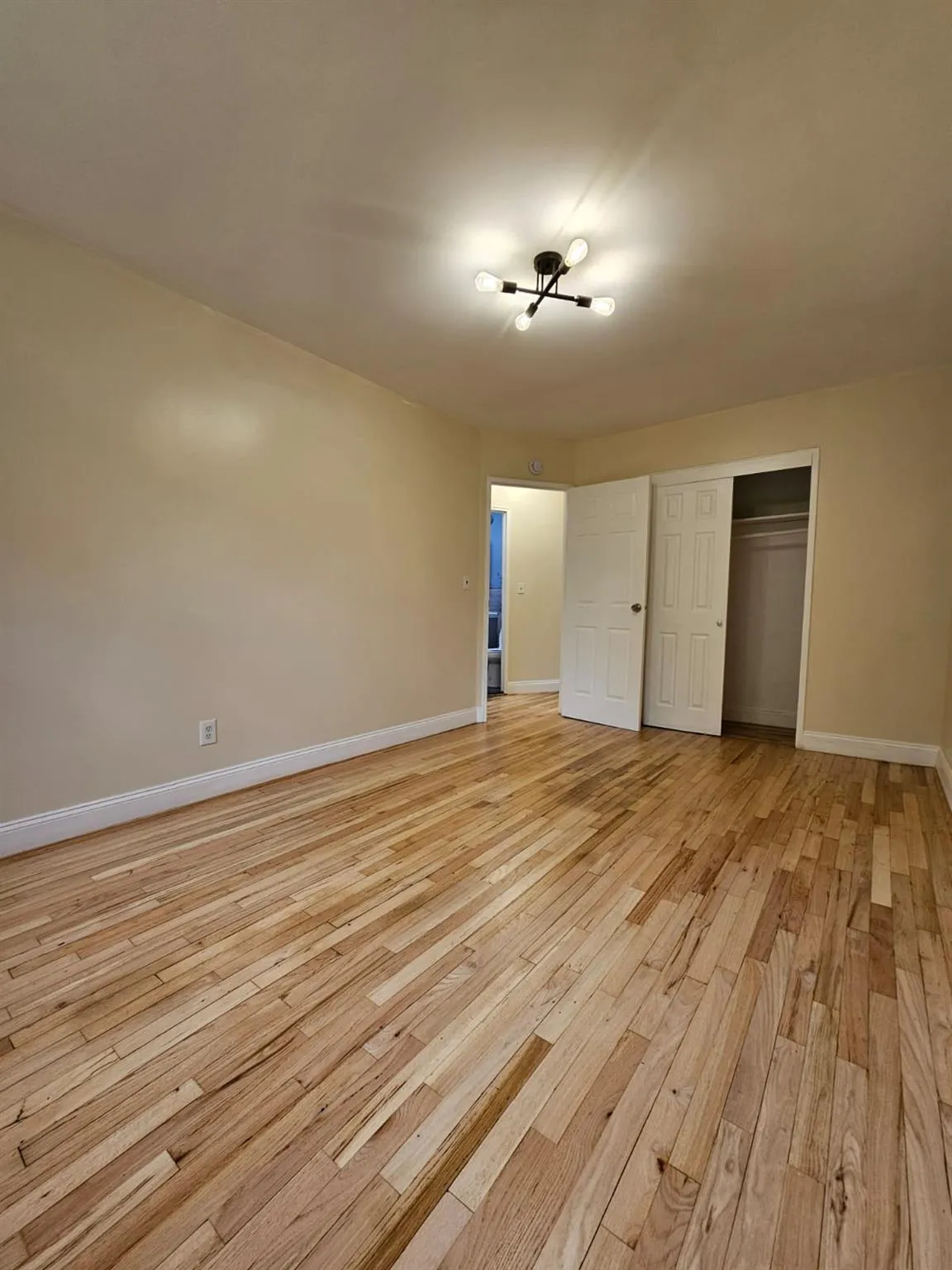 Unfurnished bedroom featuring light wood-style floors and a closet Unfurnished bedroom featuring light wood-style floors and a closet