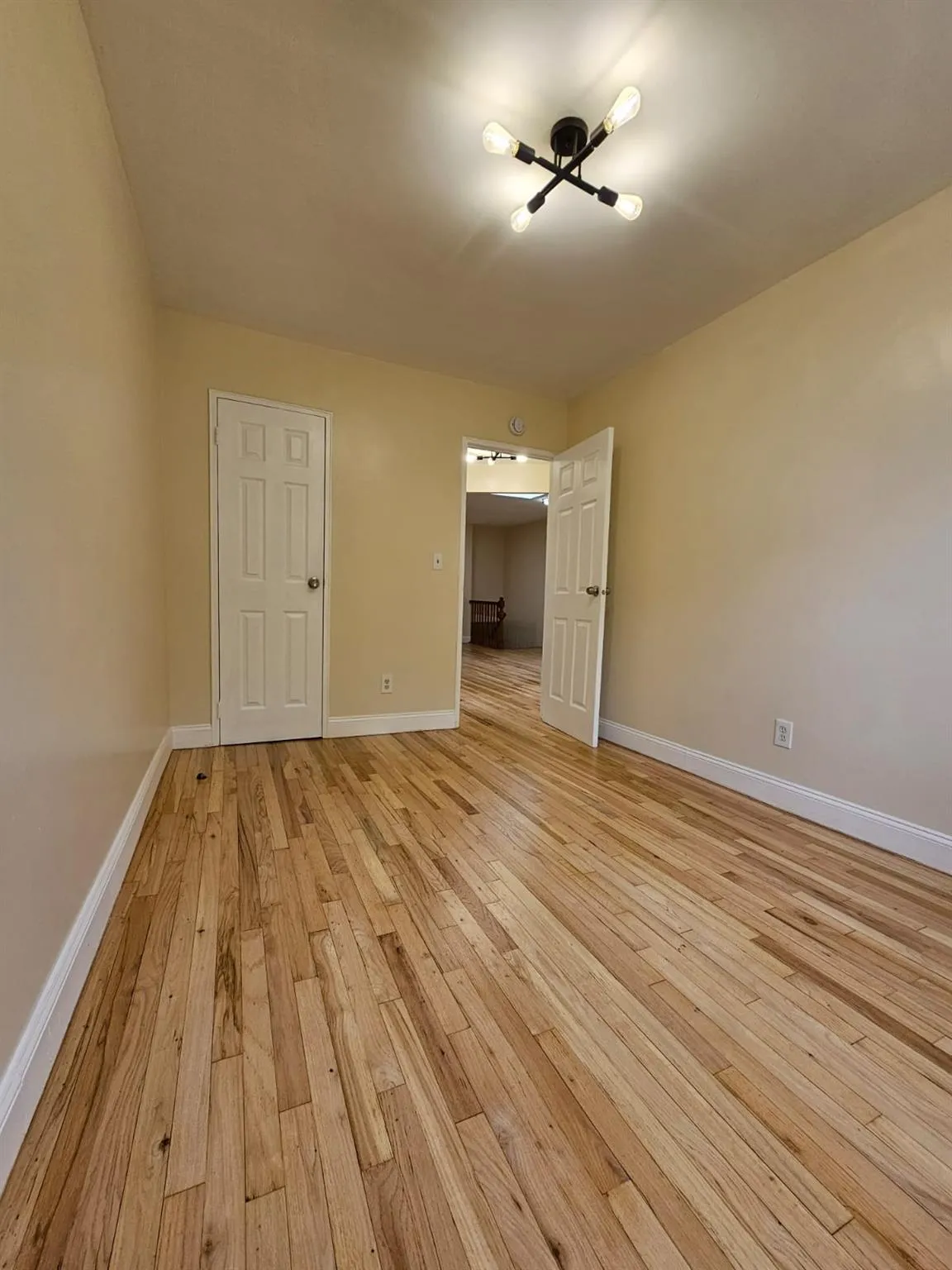 Unfurnished room featuring light wood-style flooring and baseboards Unfurnished room featuring light wood-style flooring and baseboards