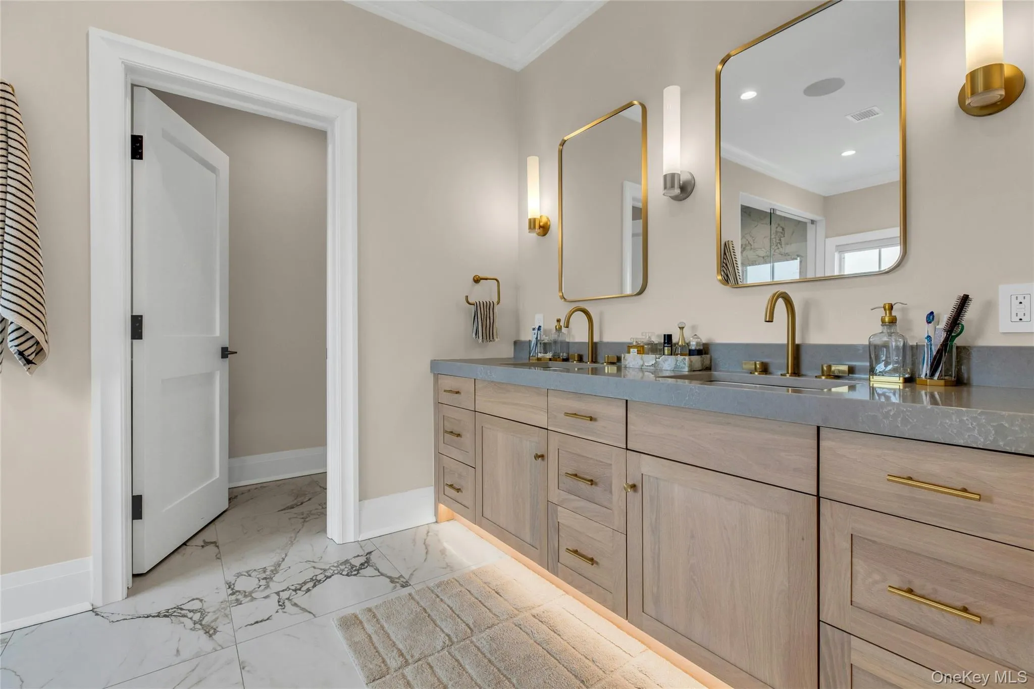 Full bath with crown molding, marble look tile flooring, double vanity, and recessed lighting Full bath with crown molding, marble look tile flooring, double vanity, and recessed lighting
