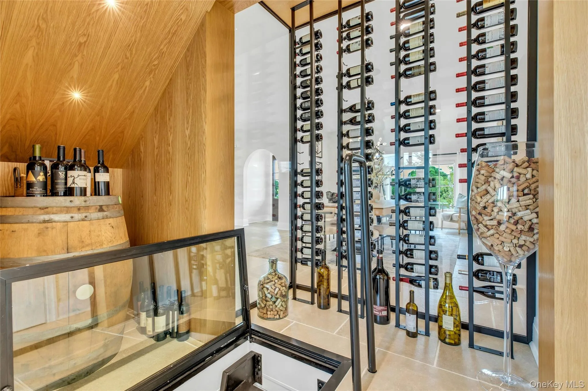 Wine room featuring arched walkways and wood walls Wine room featuring arched walkways and wood walls