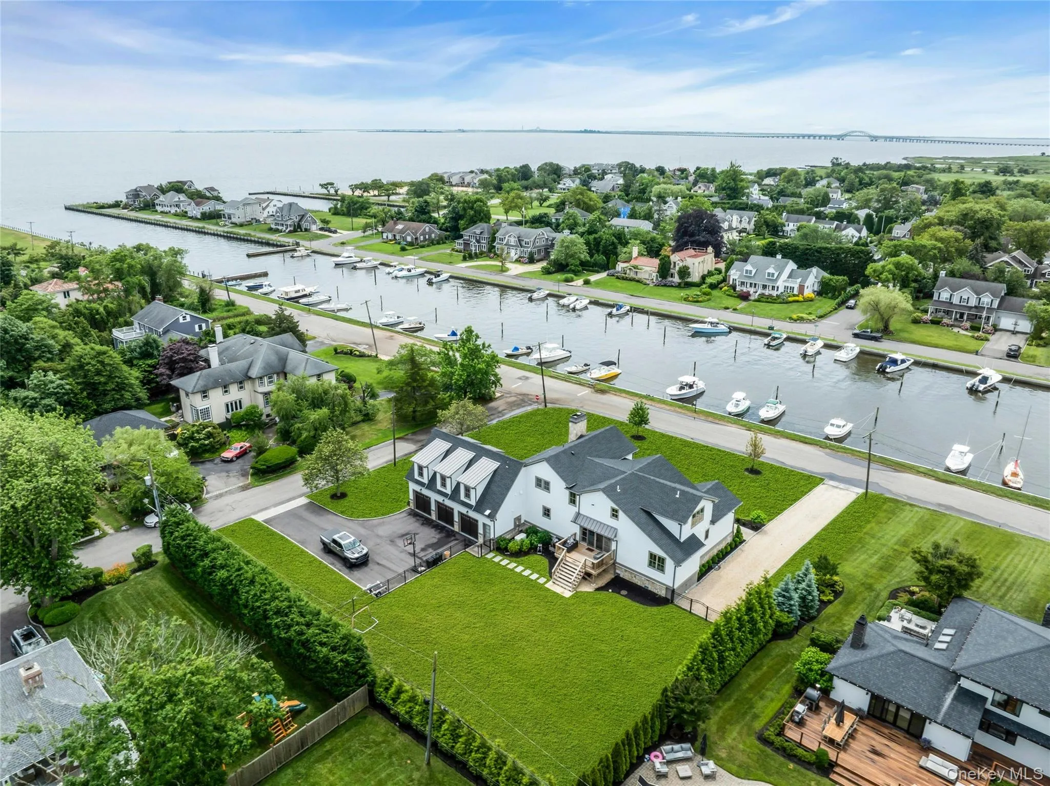 Aerial perspective of suburban area featuring a large body of water Aerial perspective of suburban area featuring a large body of water