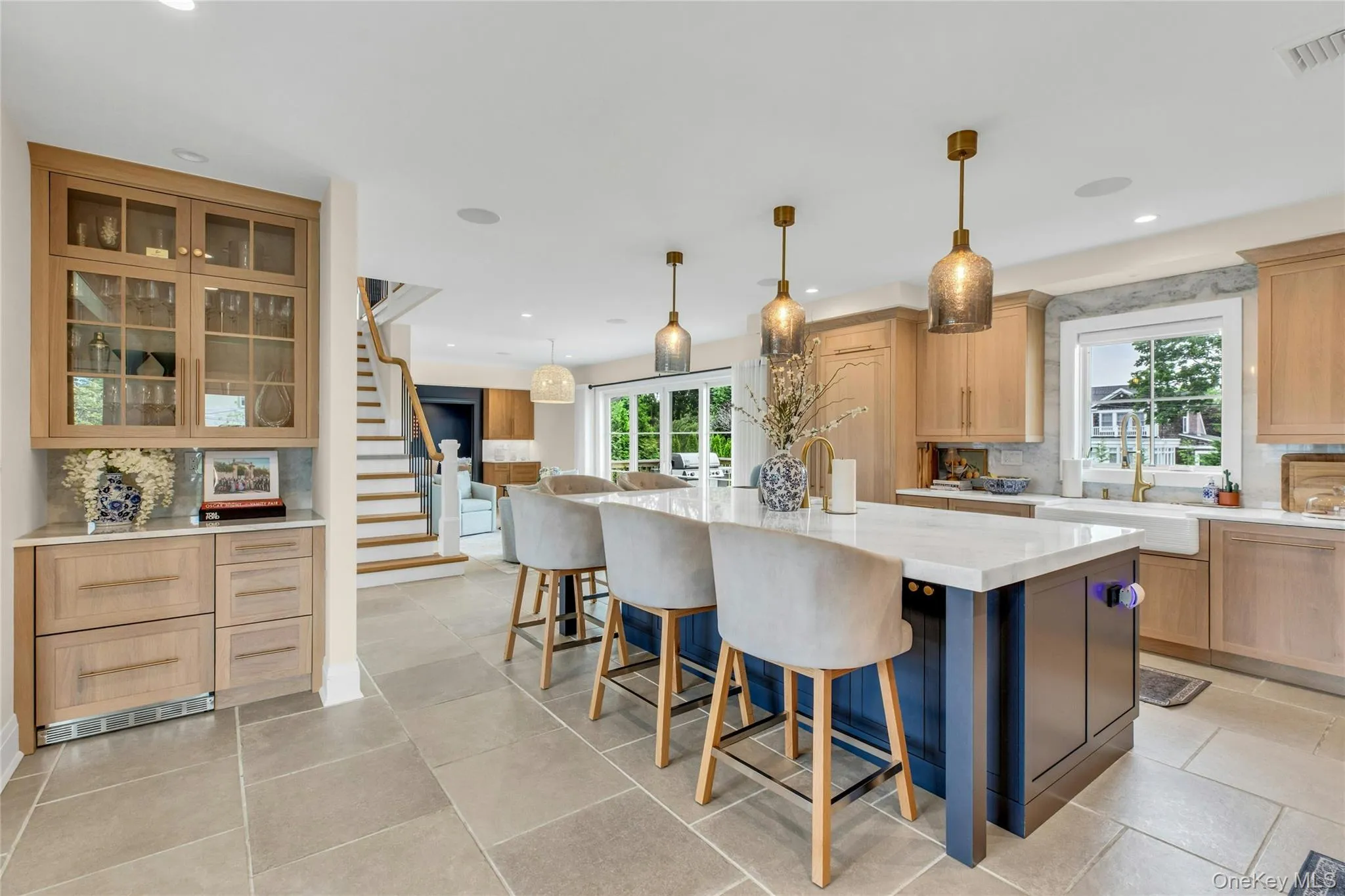 Kitchen featuring healthy amount of natural light, backsplash, a breakfast bar area, recessed lighting, and a kitchen island Kitchen featuring healthy amount of natural light, backsplash, a breakfast bar area, recessed lighting, and a kitchen island