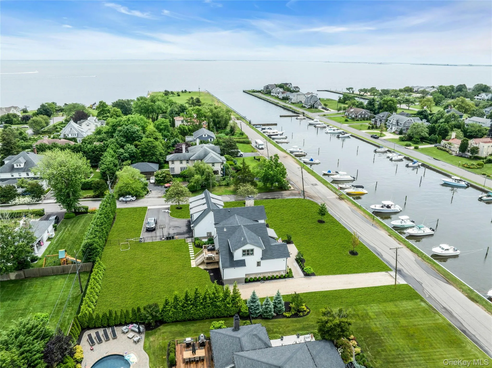 Aerial perspective of suburban area with a nearby body of water Aerial perspective of suburban area with a nearby body of water