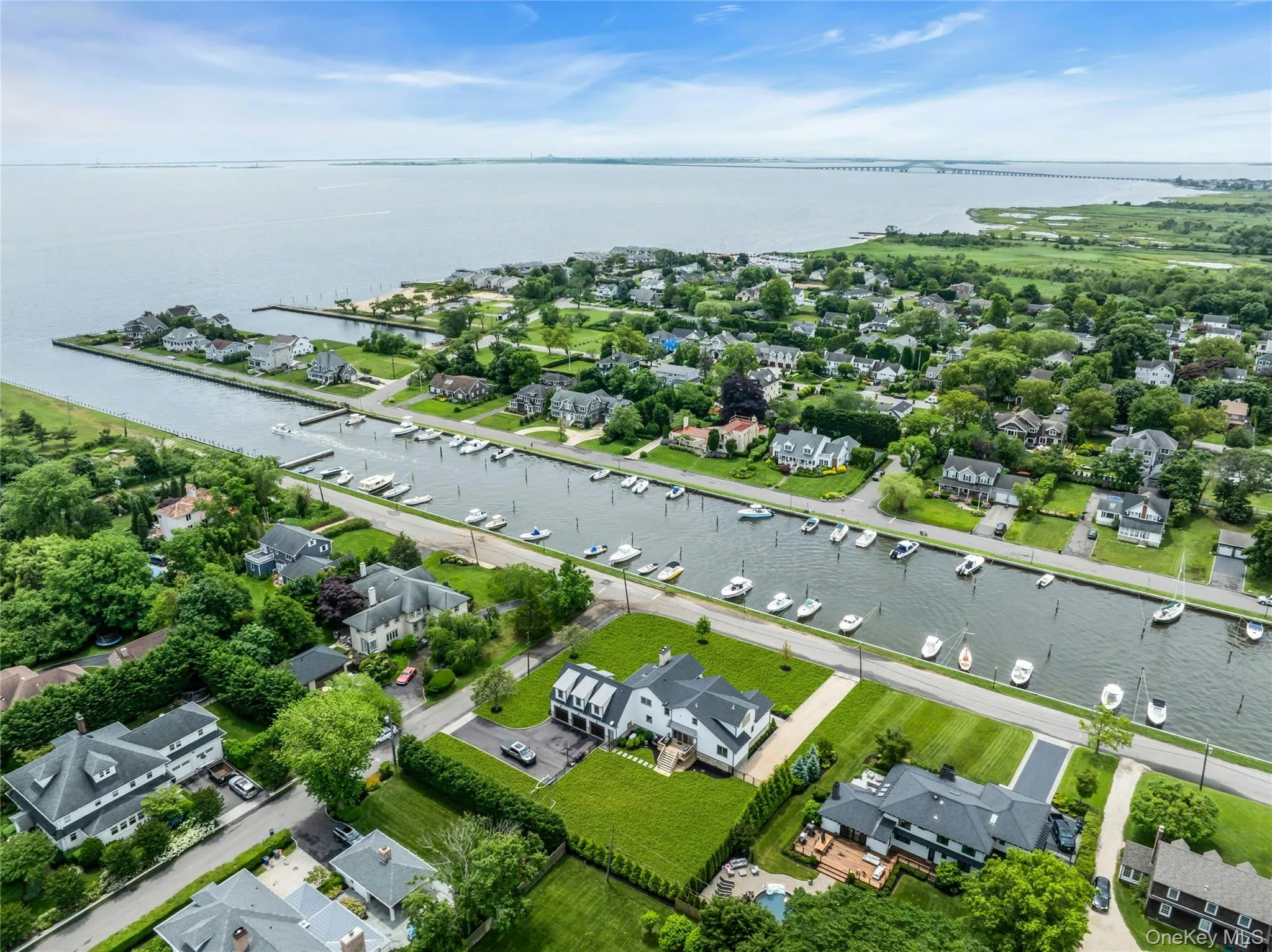 Aerial perspective of suburban area featuring a nearby body of water Aerial perspective of suburban area featuring a nearby body of water