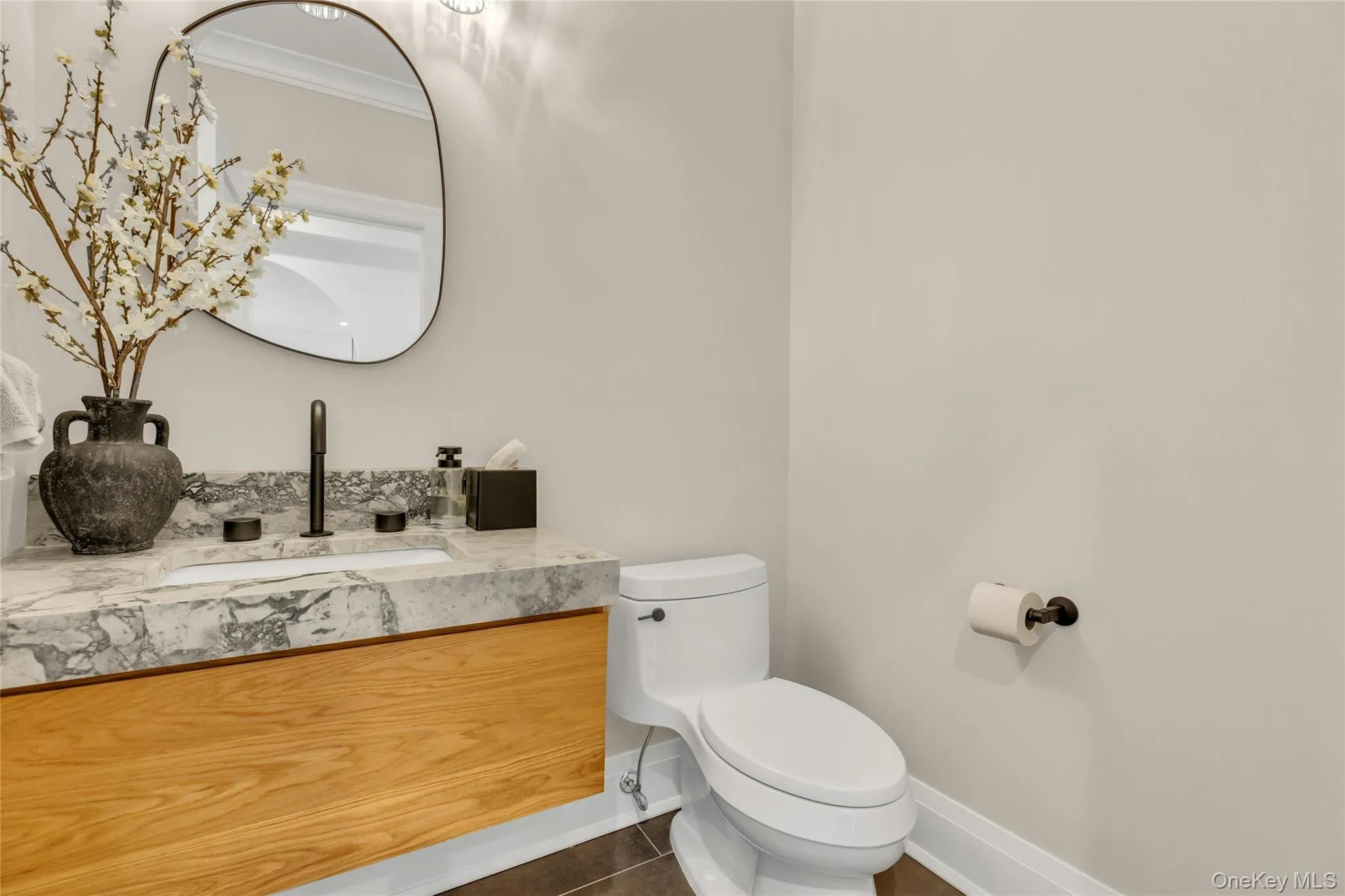Half bath with tile patterned floors, vanity, and ornamental molding Half bath with tile patterned floors, vanity, and ornamental molding