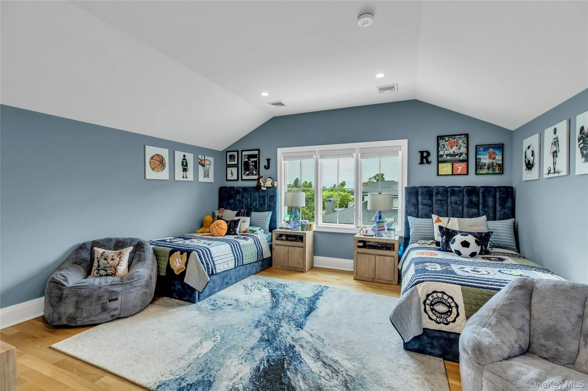 Bedroom featuring lofted ceiling and light wood-type flooring Bedroom featuring lofted ceiling and light wood-type flooring