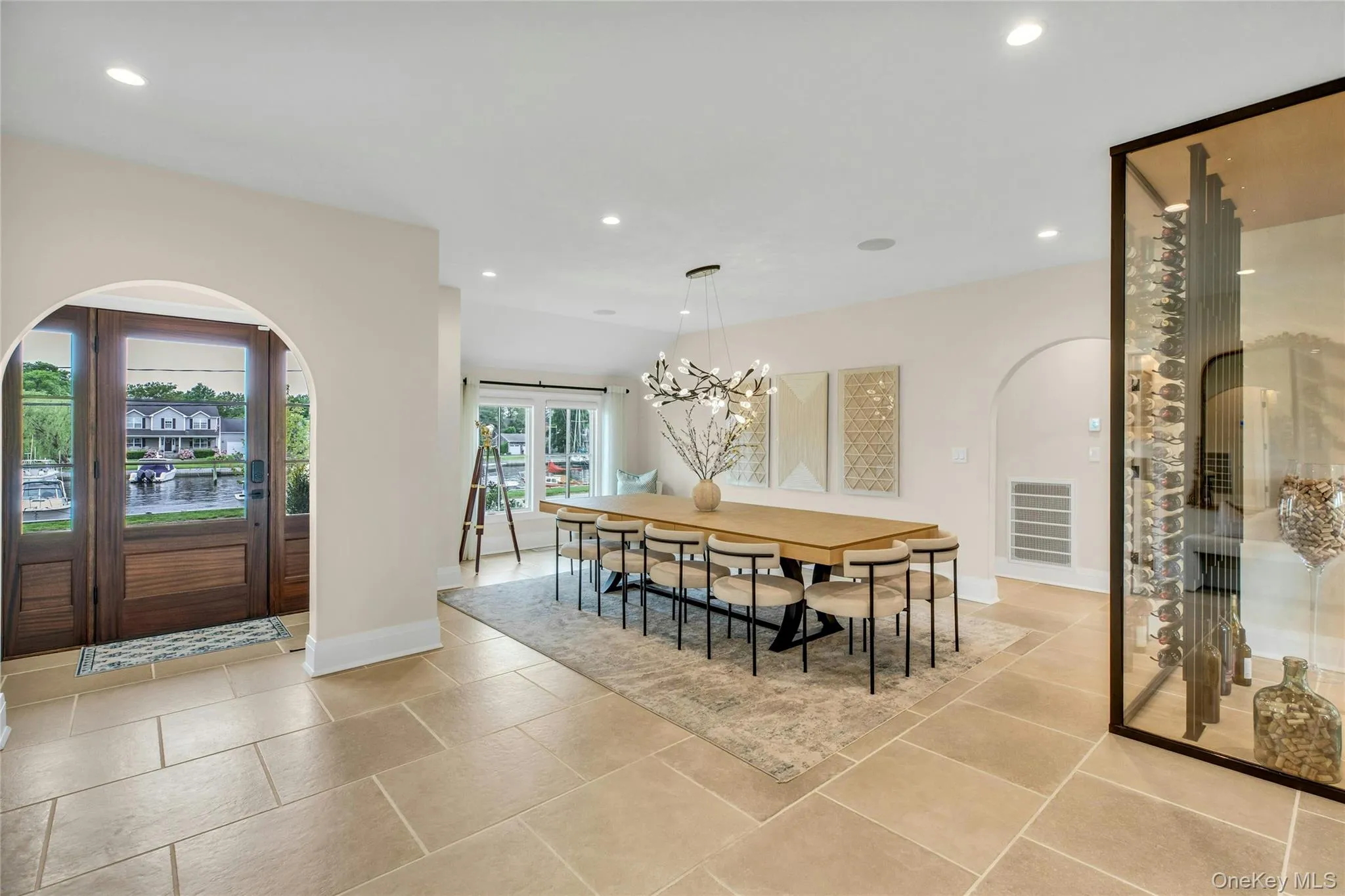 Dining area with arched walkways, recessed lighting, and a chandelier Dining area with arched walkways, recessed lighting, and a chandelier