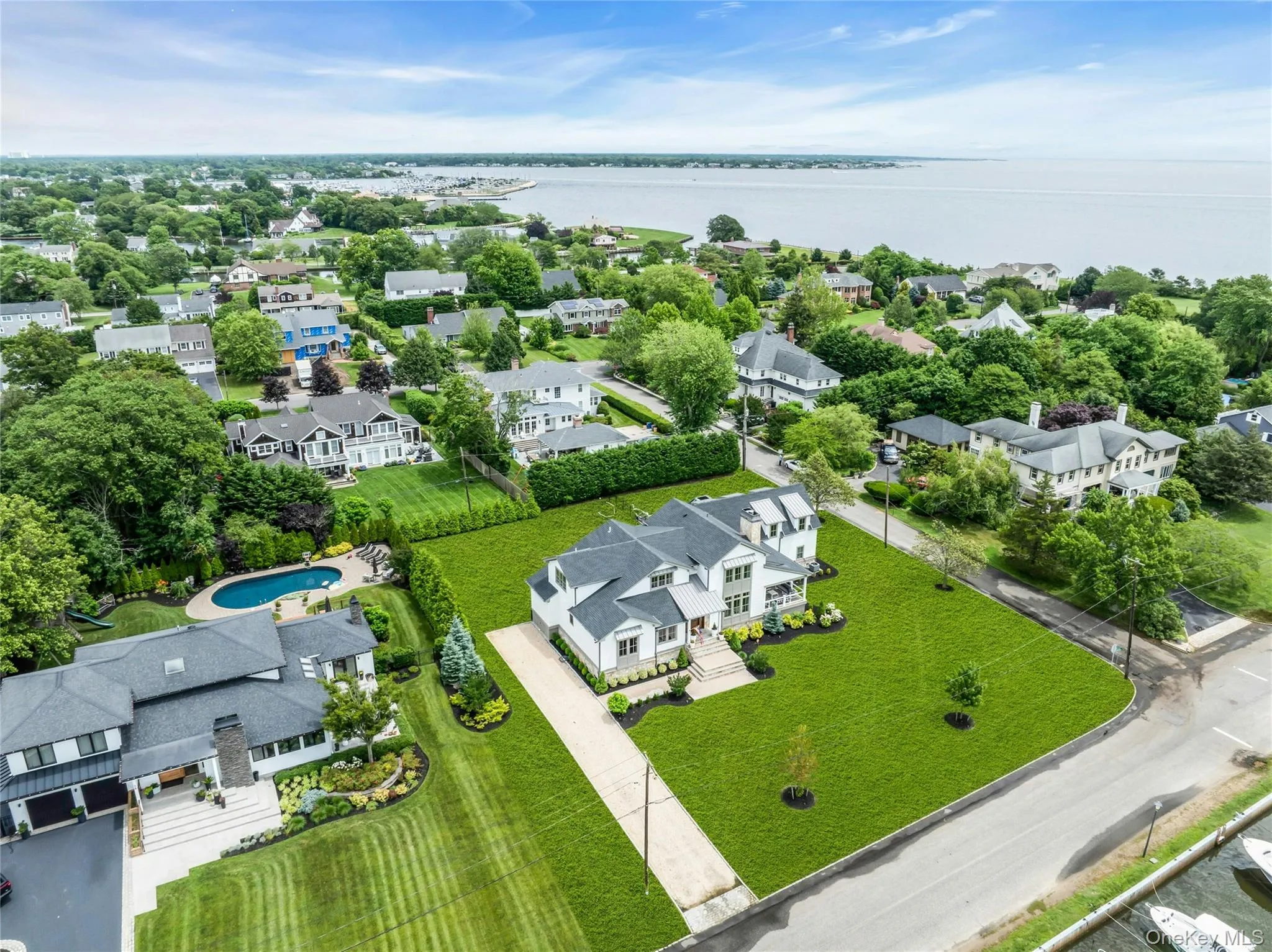 Aerial view of residential area featuring a nearby body of water Aerial view of residential area featuring a nearby body of water